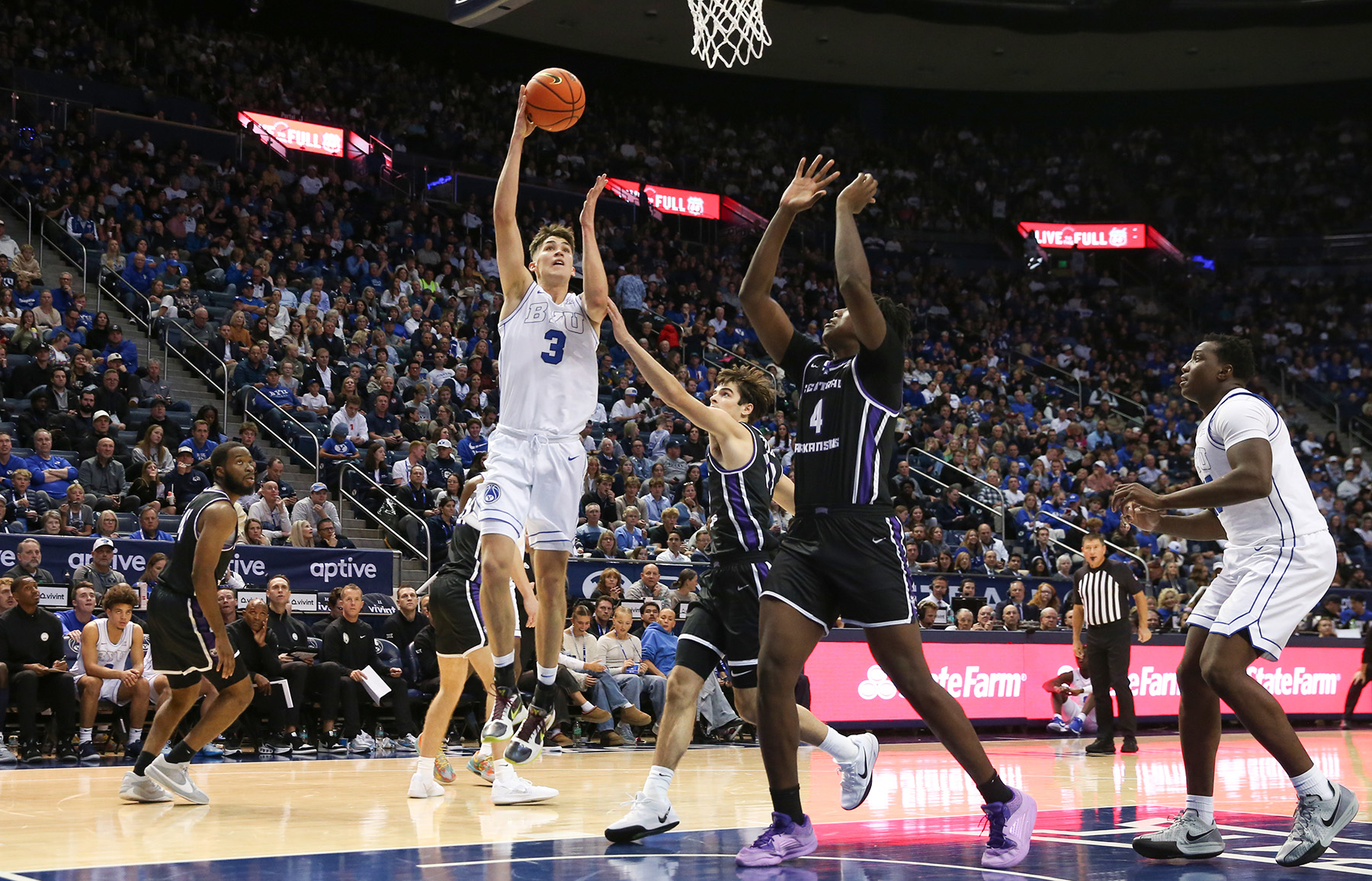 BYU guard Egor Demin jumps for a layup while a defender jumps to try to block him.