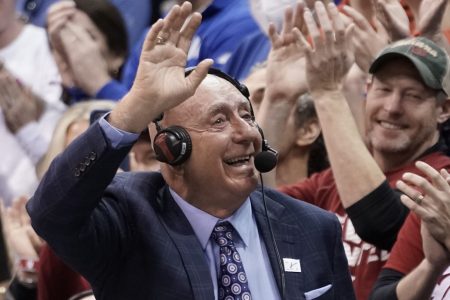 Legendary college basketball broadcaster Dick Vitale waves to the crowd while at a game
