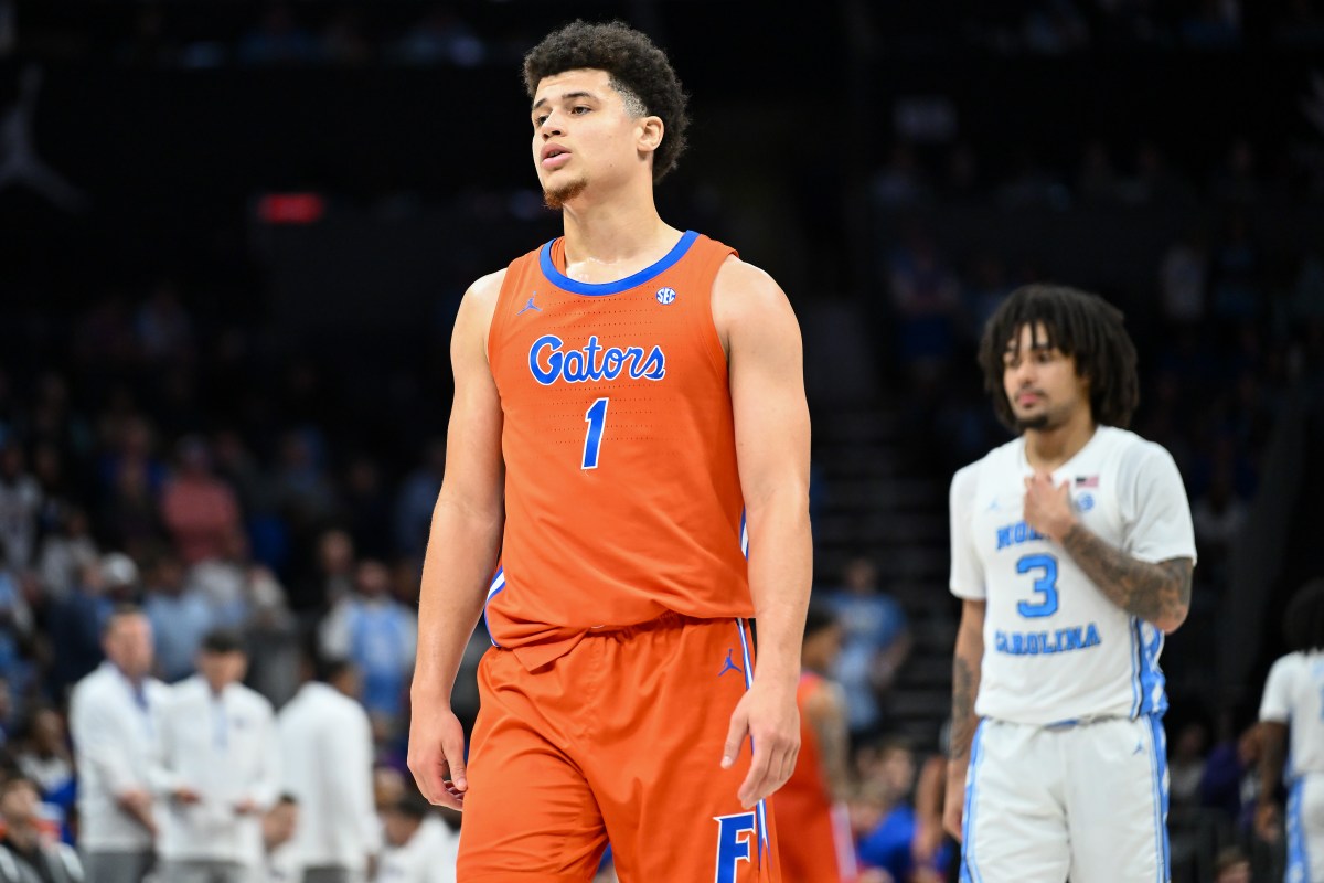 Walter Clayton of the Florida Gators. A North Carolina player is blurred in the background.