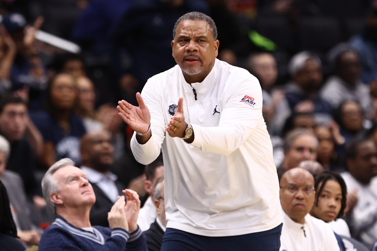 Georgetown men's basketball coach Ed Cooley claps on the sideline