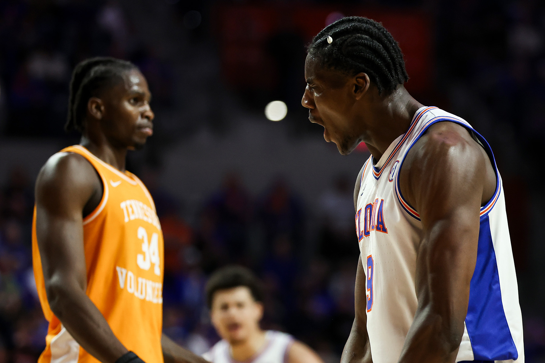 Florida center Rueben Chinyelu flexes and screams in the face of a Tennessee defender.