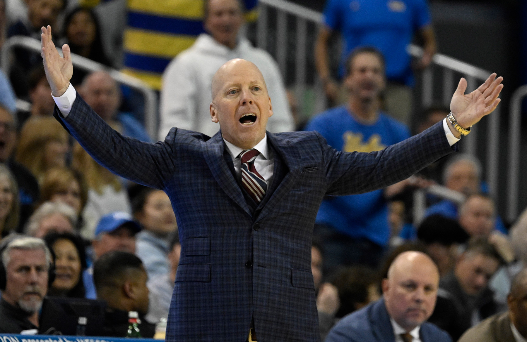 UCLA head coach Mick Cronin with his hands in the air.