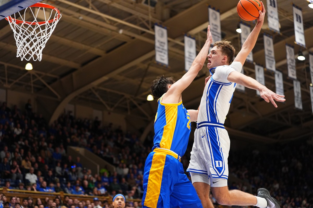 Duke forward Cooper Flagg flies through the air for a dunk.
