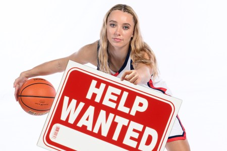 UConn guard Paige Bueckers holding a Help Wanted sign