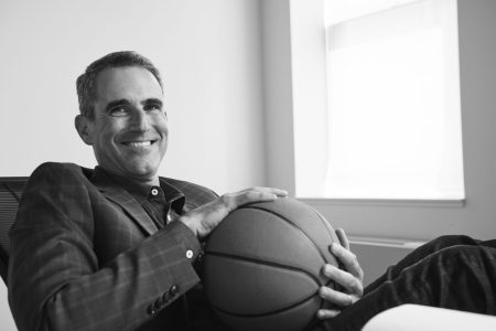 Hoops HQ Editor-in-Chief Seth Davis sits behind a desk and cradles a basketball