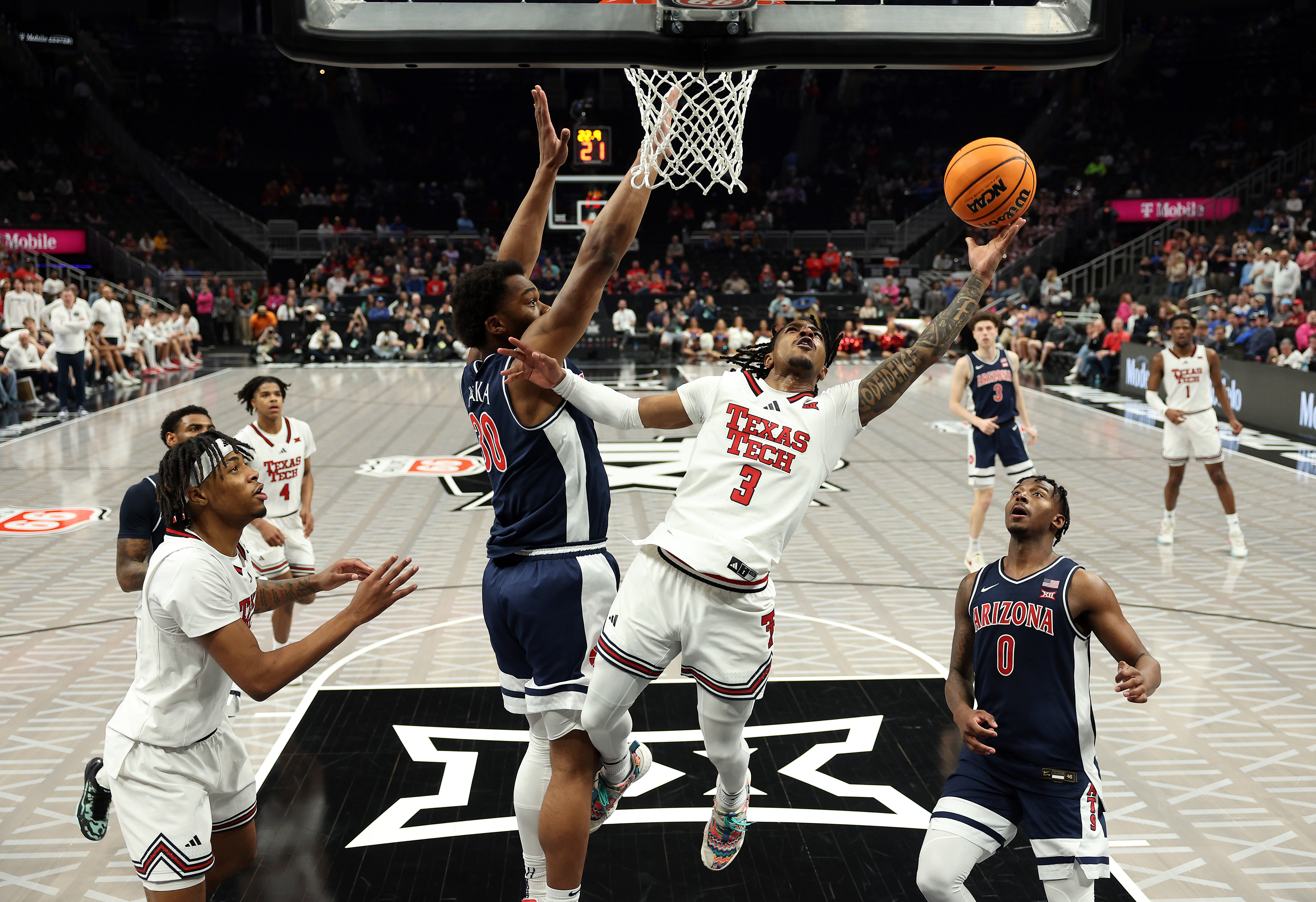 Elijah Hawkins #3 of the Texas Tech Red Raiders drives to the basket as Tobe Awaka #30 of the Arizona Wildcats defends during the semifinal game of the Big 12 men's basketball tournament at T-Mobile Center on March 14, 2025 in Kansas City, Missouri.