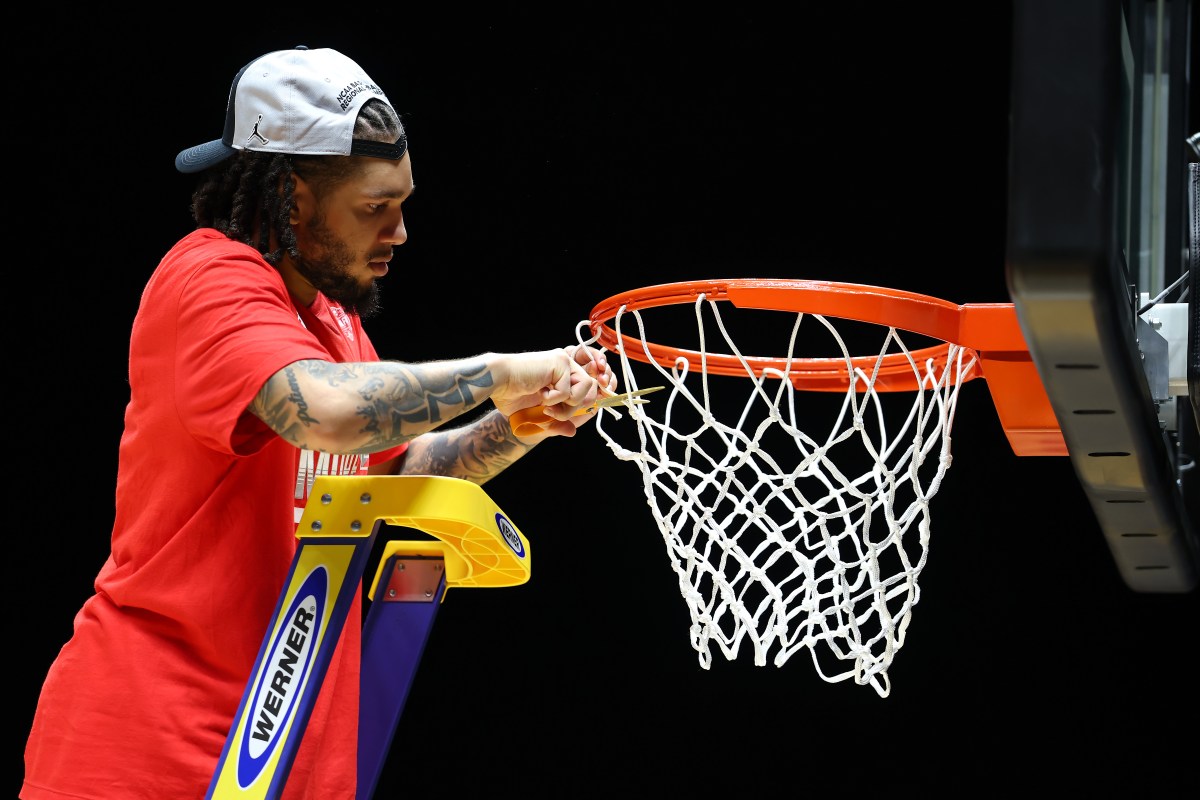 Emanuel Sharp of the Houston Cougars cuts the net down following his team's 69-50 victory against the Tennessee Volunteers in the Midwest Regional Elite Eight round of the NCAA Men's Basketball Tournament at Lucas Oil Stadium on March 30, 2025