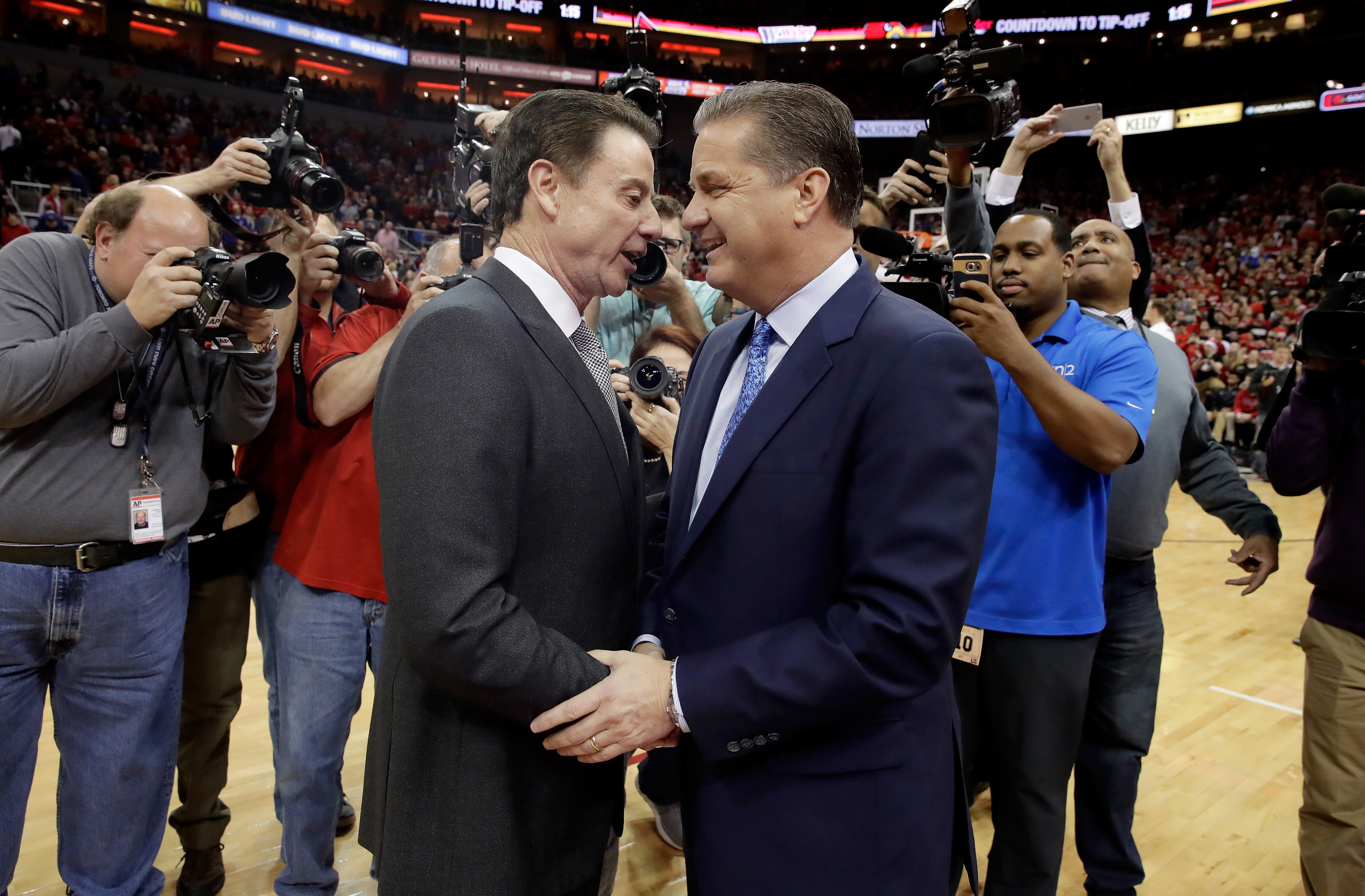 Rick Pitino the head coach of the Louisville Cardinals and John Calipari the head coach of the Kentucky Wildcats talk before the game at KFC YUM! Center on December 21, 2016 in Louisville, Kentucky.