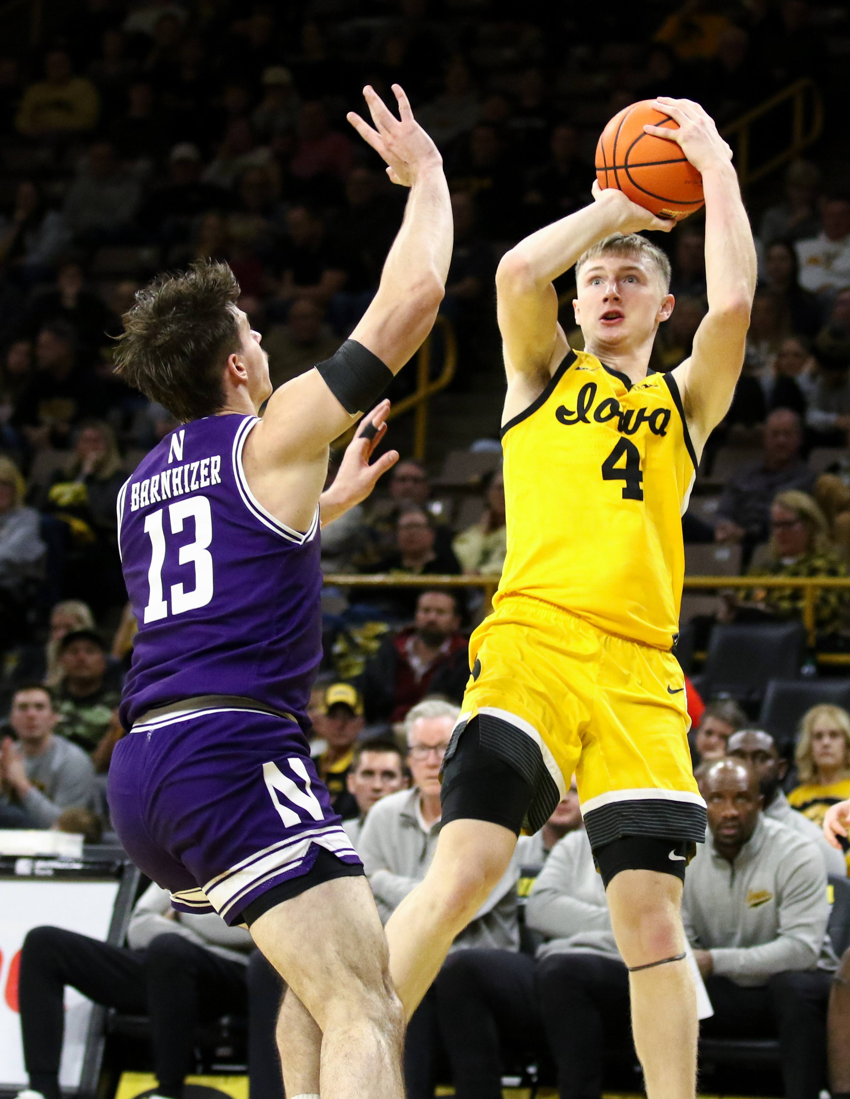Guard Josh Dix of the Iowa Hawkeyes takes a shot during the second half against guard Brooks Barnhizer #13 of the Northwestern Wildcats, at Carver-Hawkeye Arena on December 3, 2024 in Iowa City, Iowa.