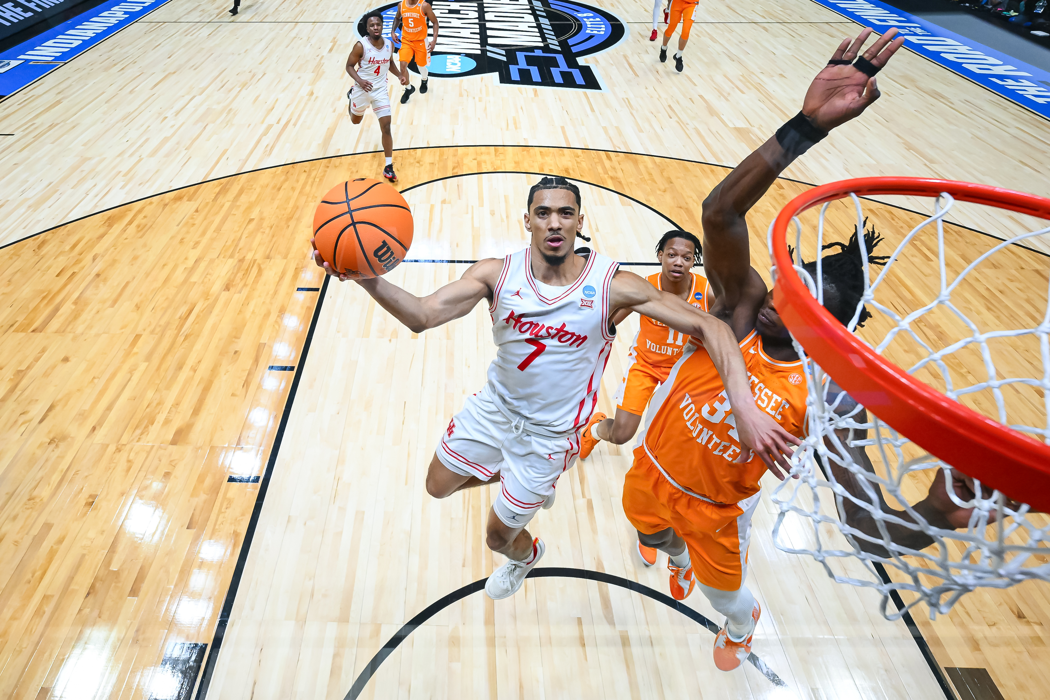 Milos Uzan of the Houston Cougars shoots the ball against Felix Okpara #34 of the Tennessee Volunteers in the Elite Eight round of the 2025 NCAA Men's Basketball Tournament
