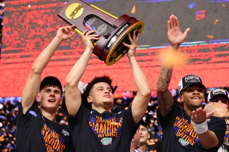 Walter Clayton Jr. and his teammates celebrate with the championship trophy as confetti rains down on April 07, 2025
