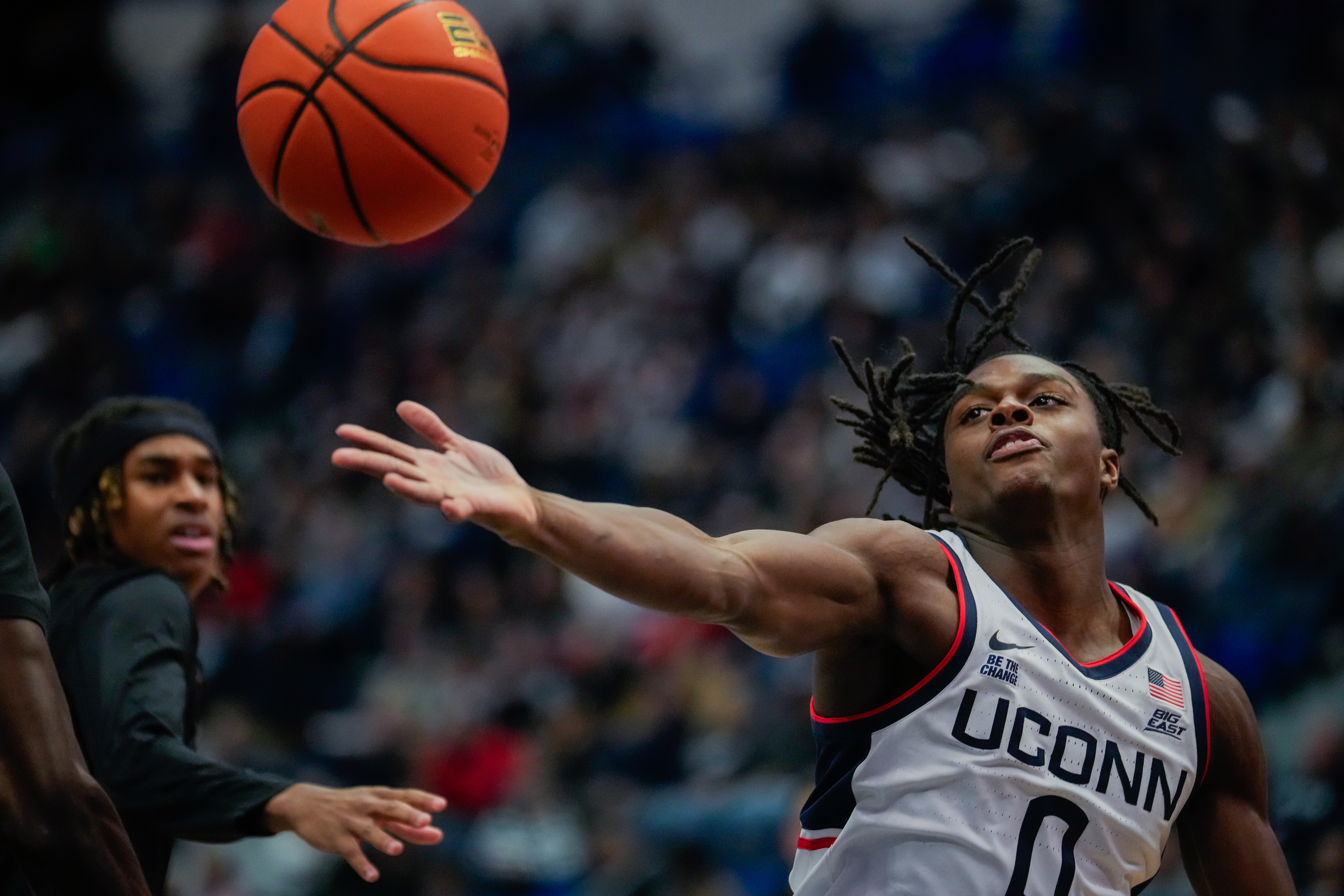 UConn basketball player Ahmad Nowell reaches for a loose ball against the Maryland Eastern Shore Hawks