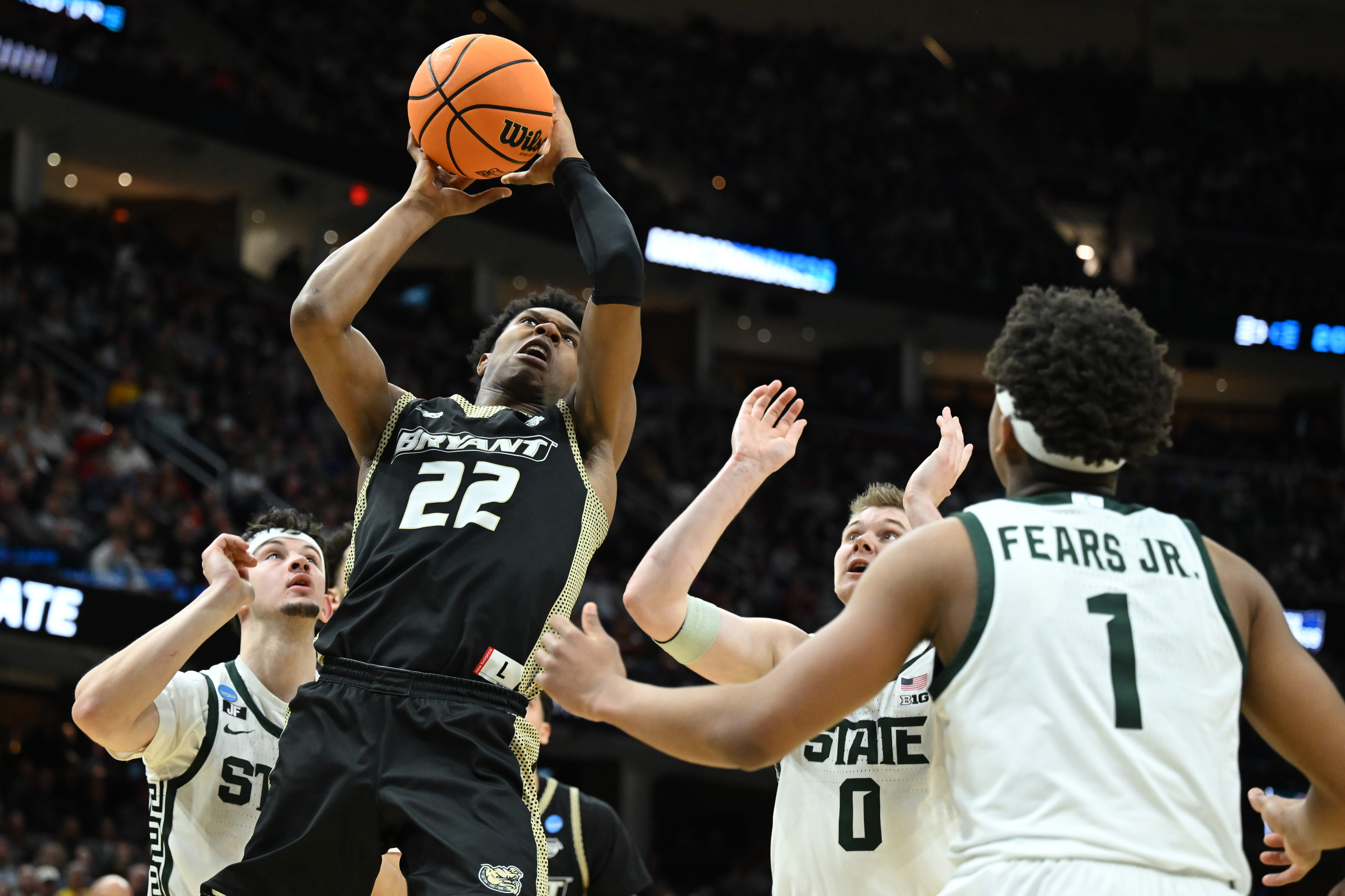 Bryant University basketball player Keyshawn Mitchell goes up for a shot.