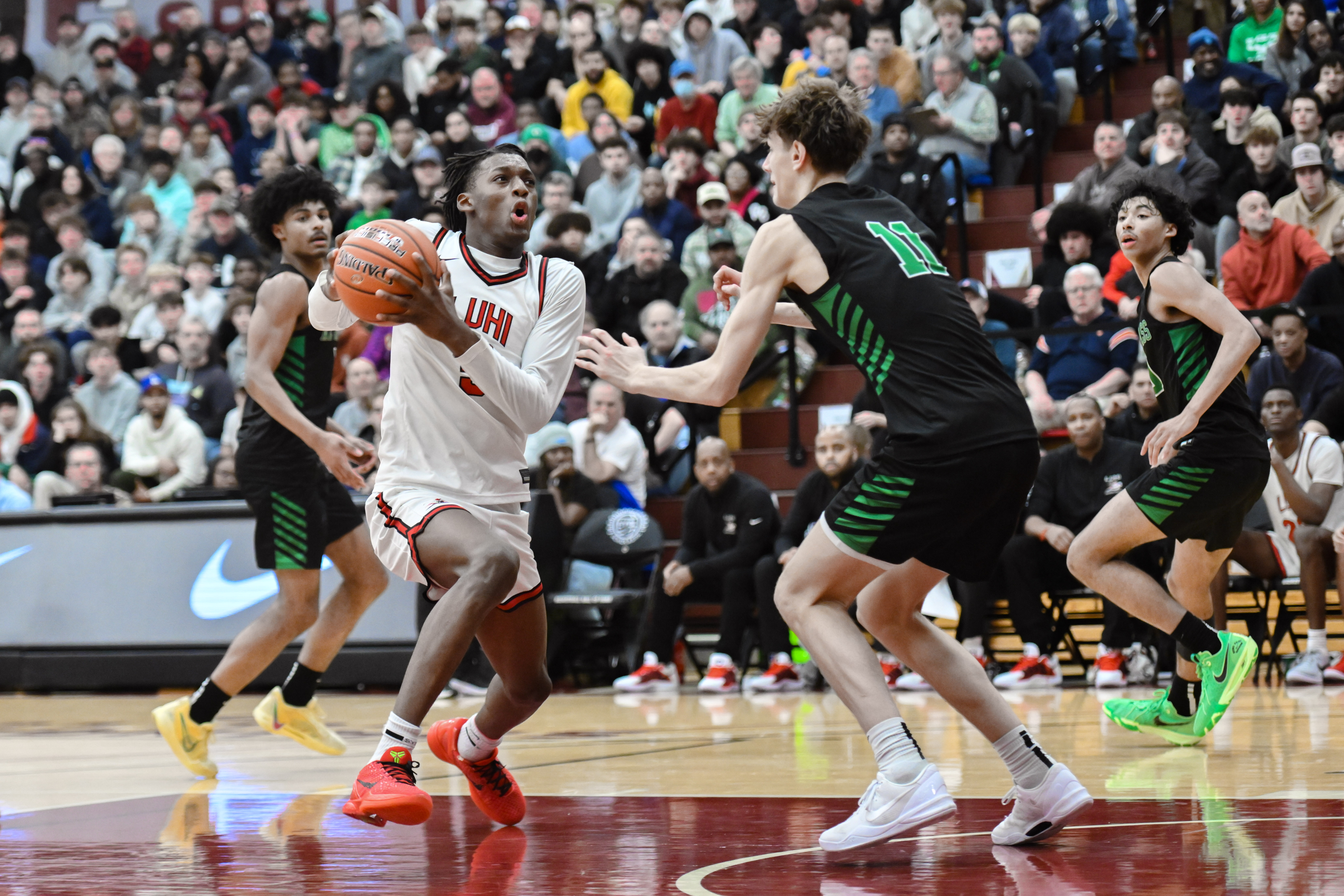 Dylan Mingo of Long Island Lutheran drives to the basket while being defended by Davis Fogle of Arizona Compass Prep