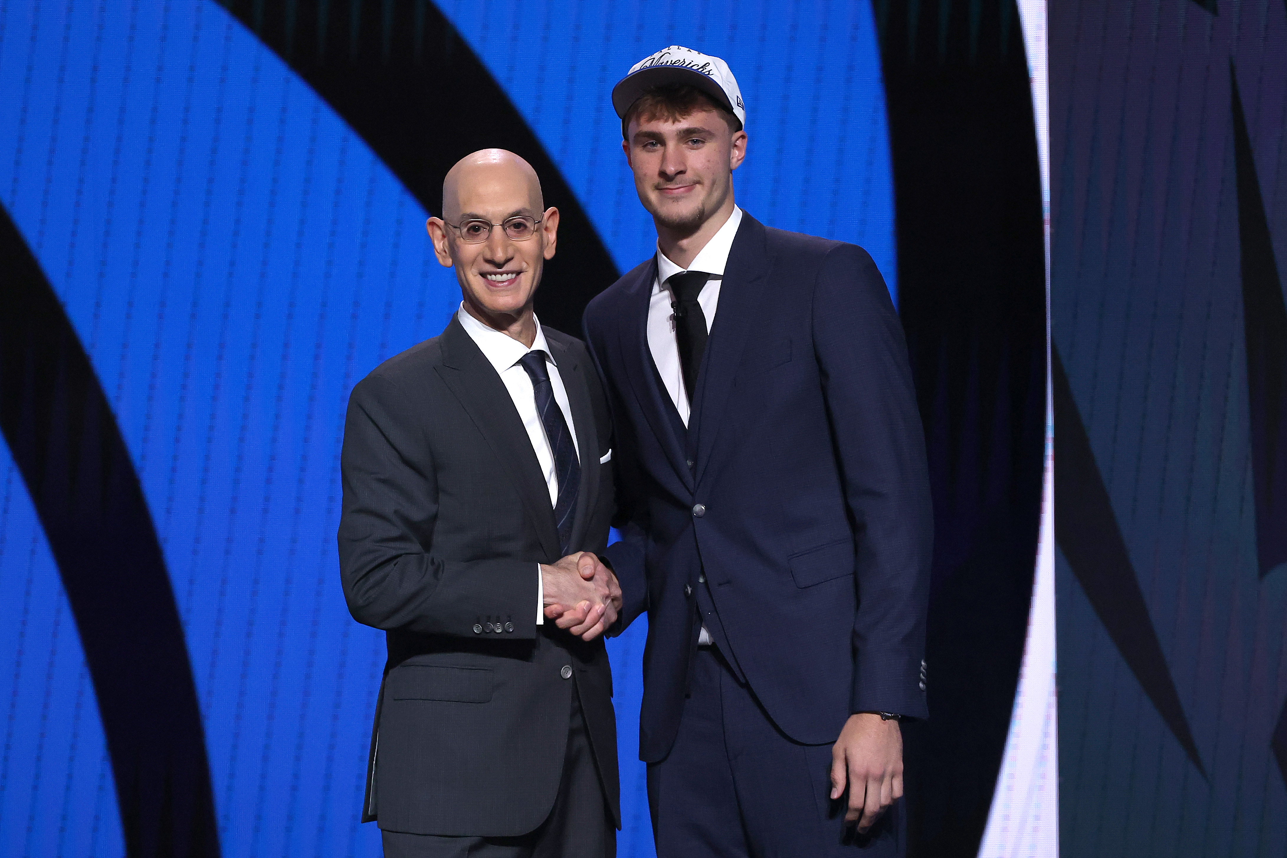 Cooper Flagg shakes hands with NBA Commissioner Adam Silver, as he becomes the youngest first overall pick since LeBron James in 2003