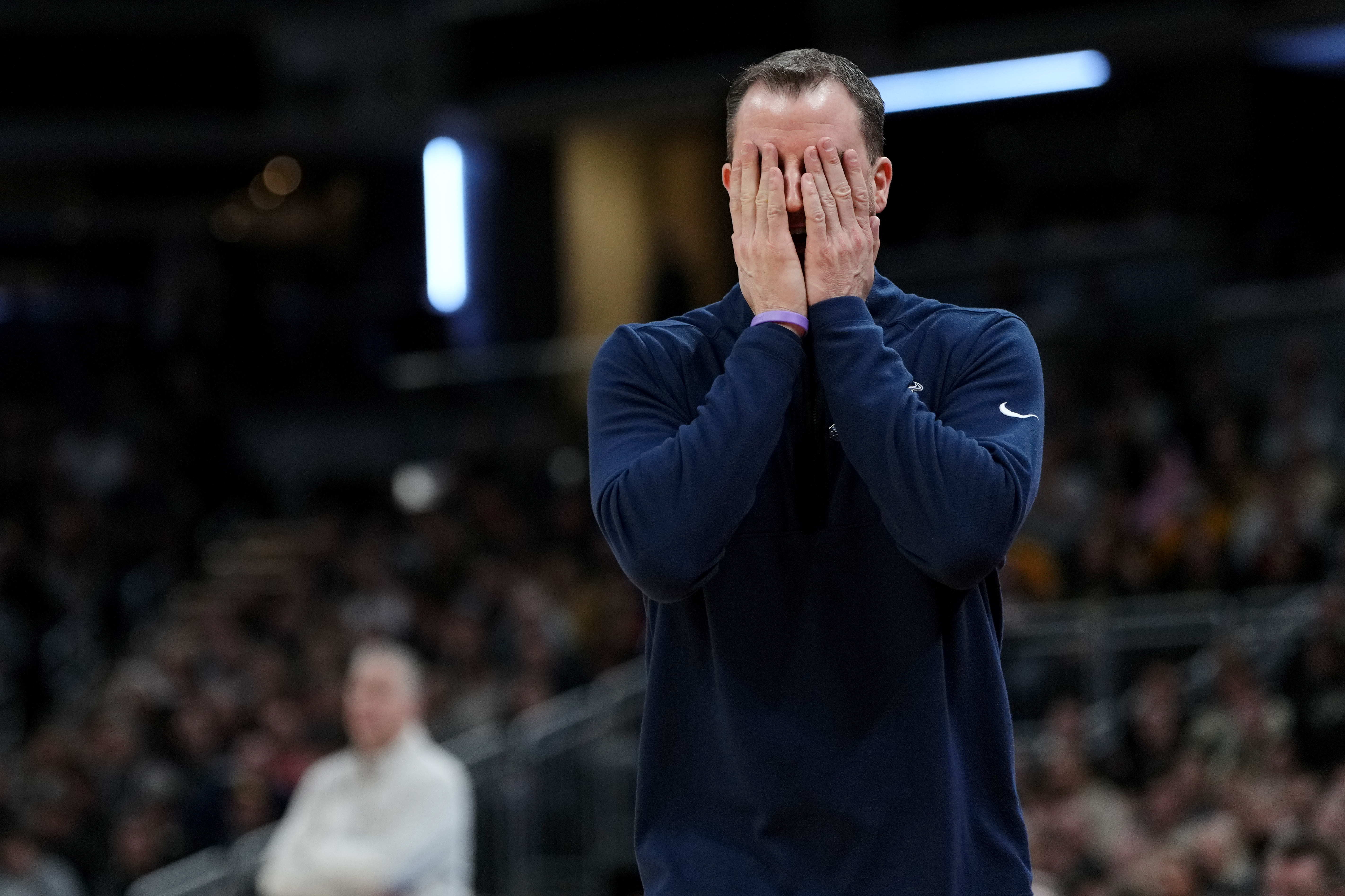 Danny Sprinkle buries his face in his hands during Utah State's Second Round loss to Purdue during the 2024 NCAA Tournament
