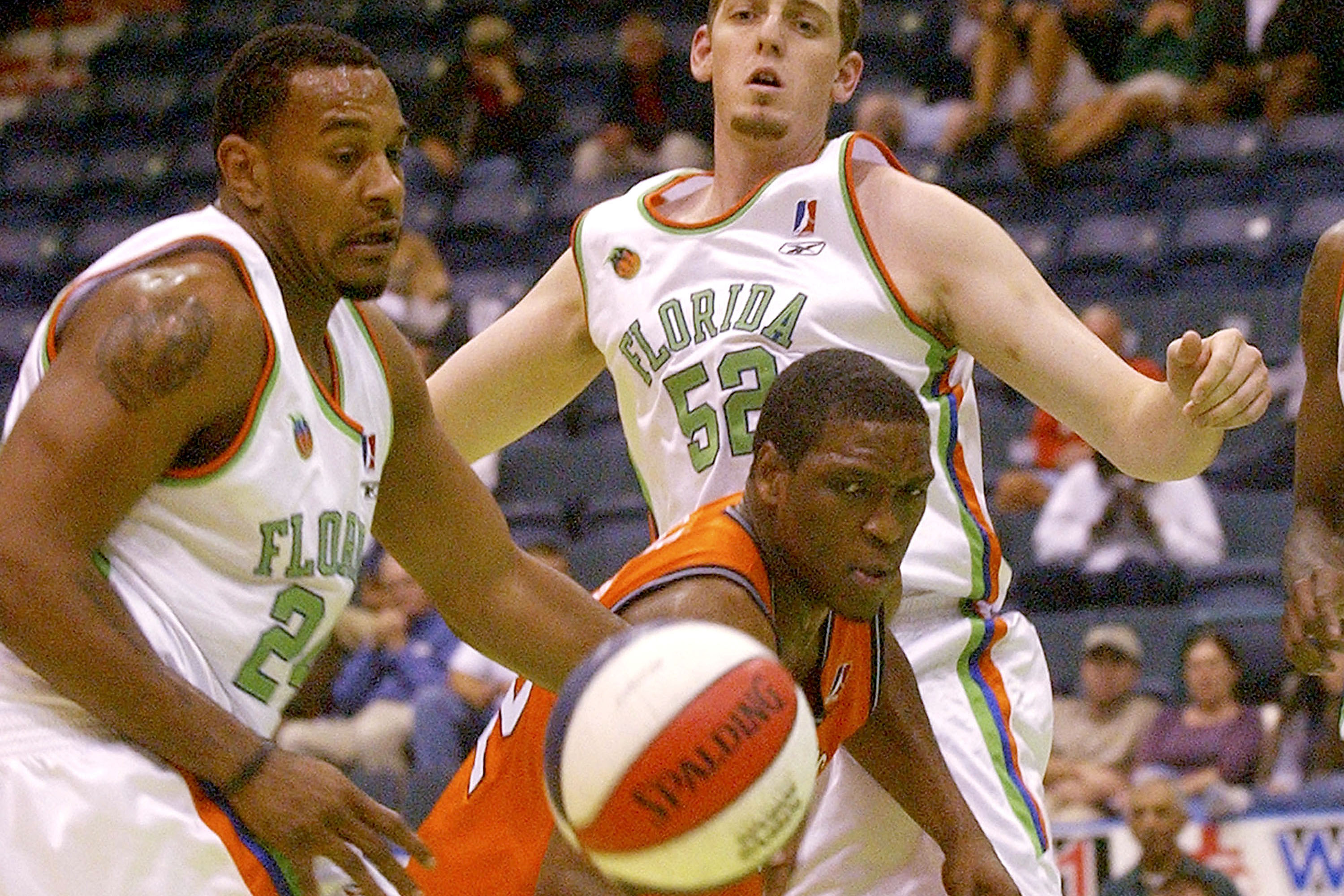 Collins's father, DeAngelo battles for a rebound as a member of the NBA Development League's Florida Flame in 2004