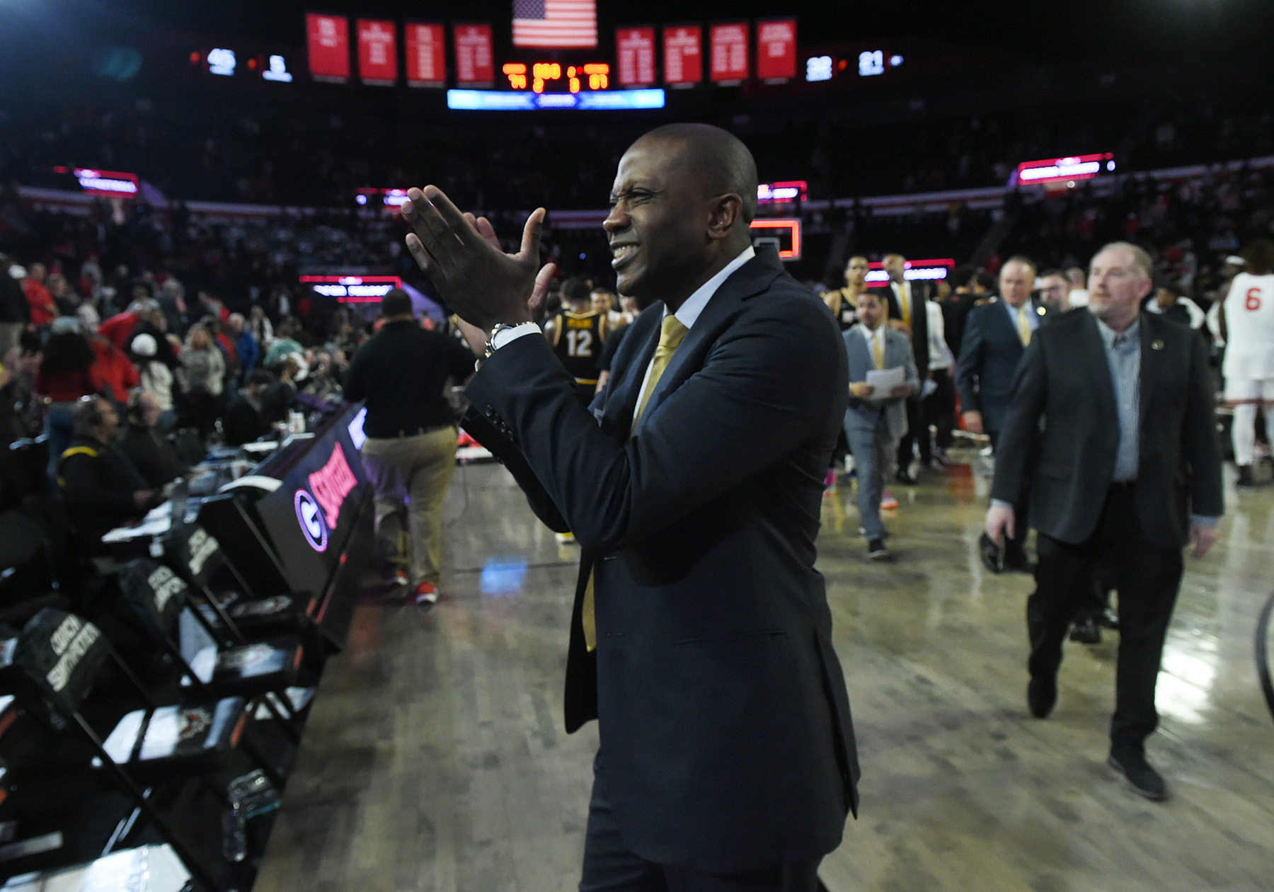 Dennis Gates claps his hands after a big victory