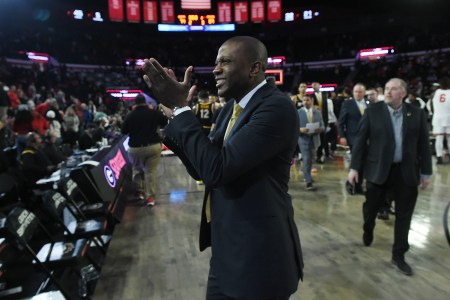 Dennis Gates claps his hands after a big victory