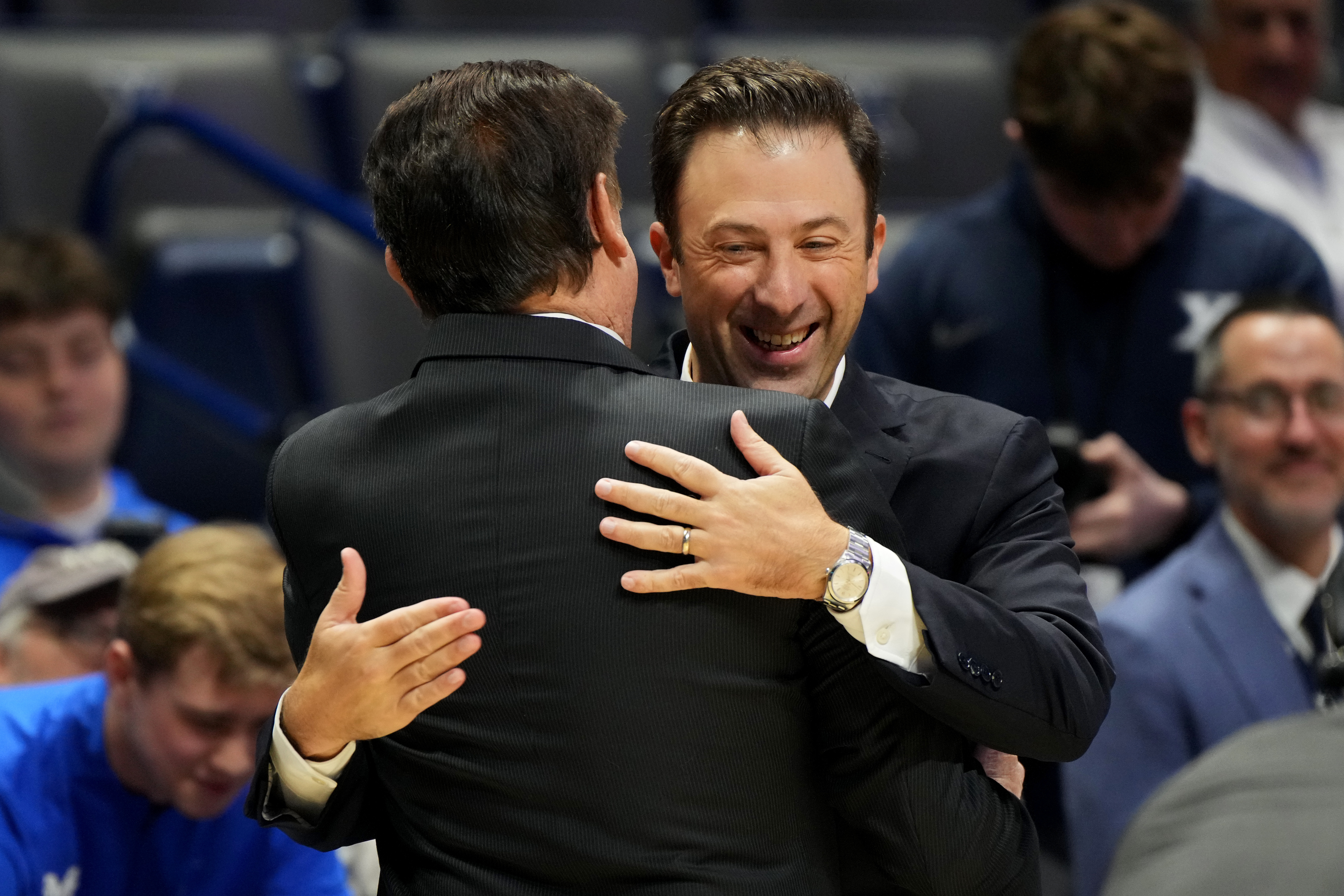 Pitino's son and Xavier head coach, Richard, embracing his father before Rick picked up his 900th career victory