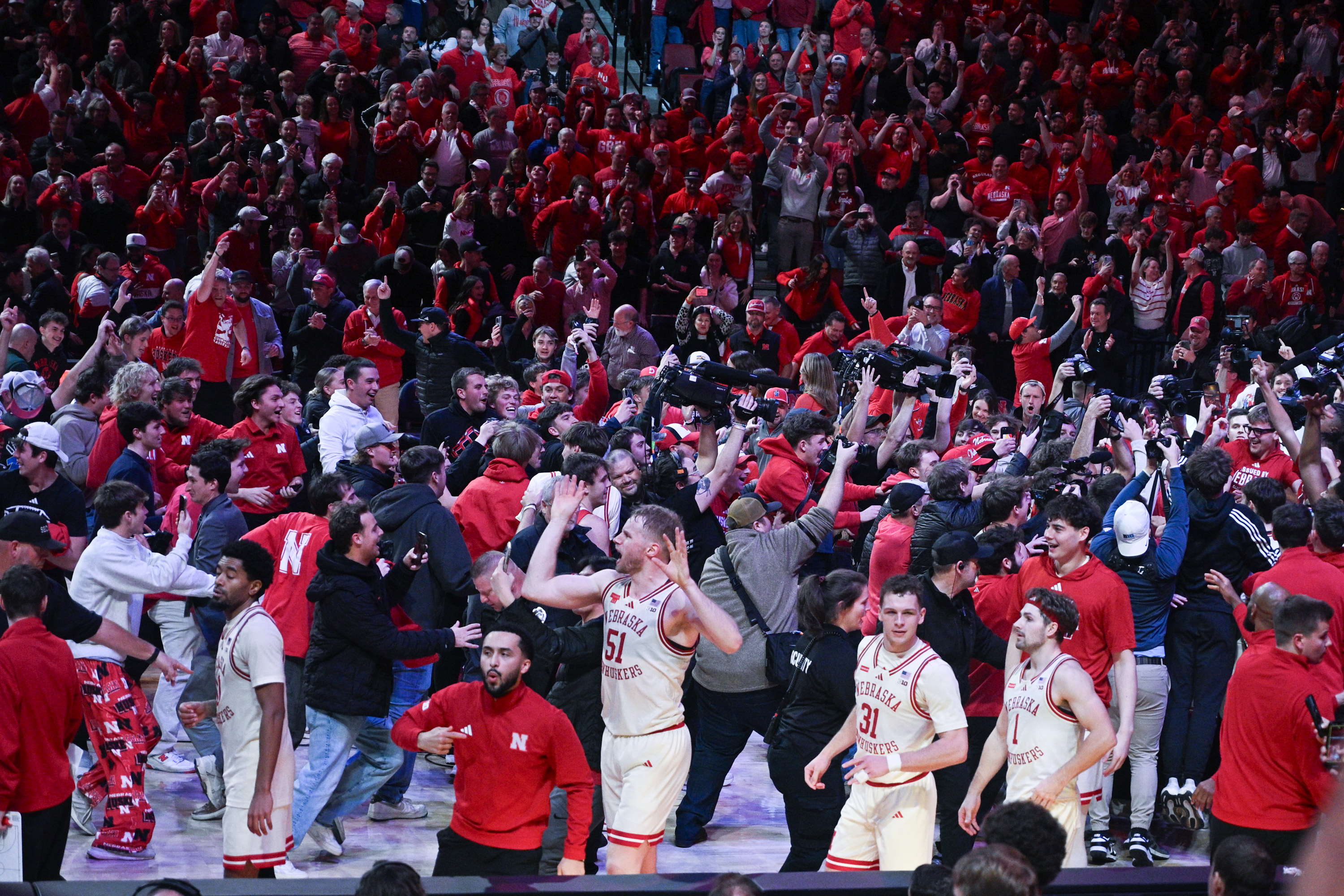 Rienk Mast (51) braves a court storm after Nebraska's win over Michigan State
