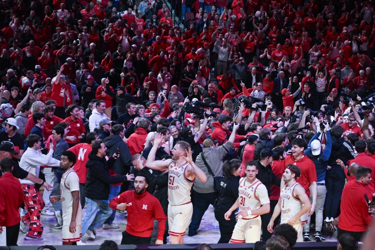 Rienk Mast (51) braves a court storm after Nebraska's win over Michigan State