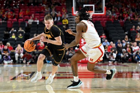 Bennett Stirtz #14 of the Iowa Hawkeyes handles the ball against Andre Mills #7 of the Maryland Terrapins