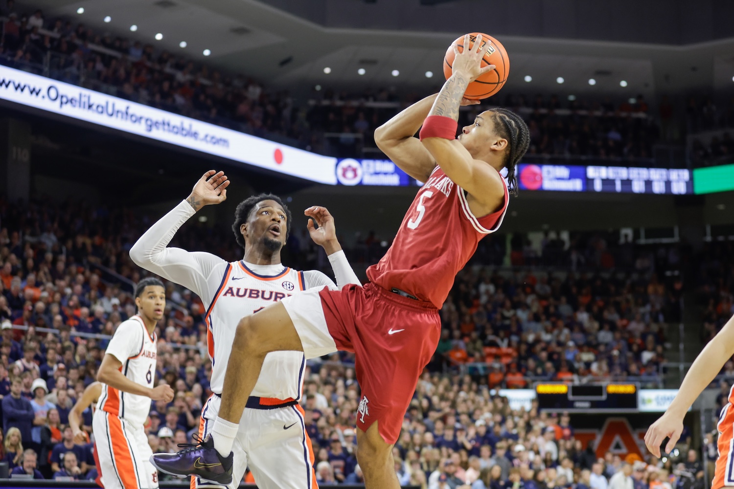 Darius Acuff Jr. of Arkansas pulls up for a fadeaway over Auburn's Kevin Overton