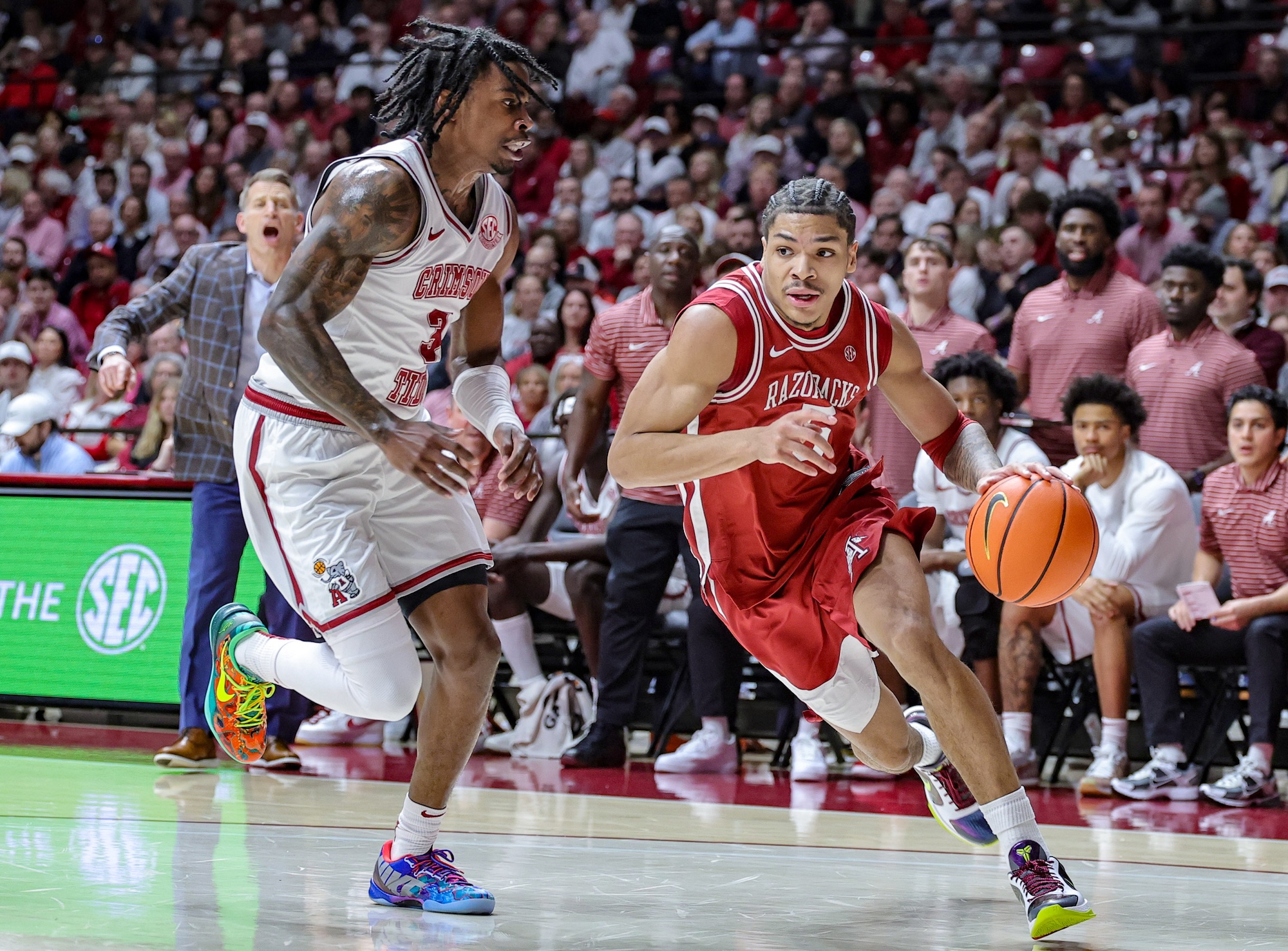 Darius Acuff Jr. of the Arkansas Razorbacks drives to the basket around Latrell Wrightsell Jr. of the Alabama Crimson Tide