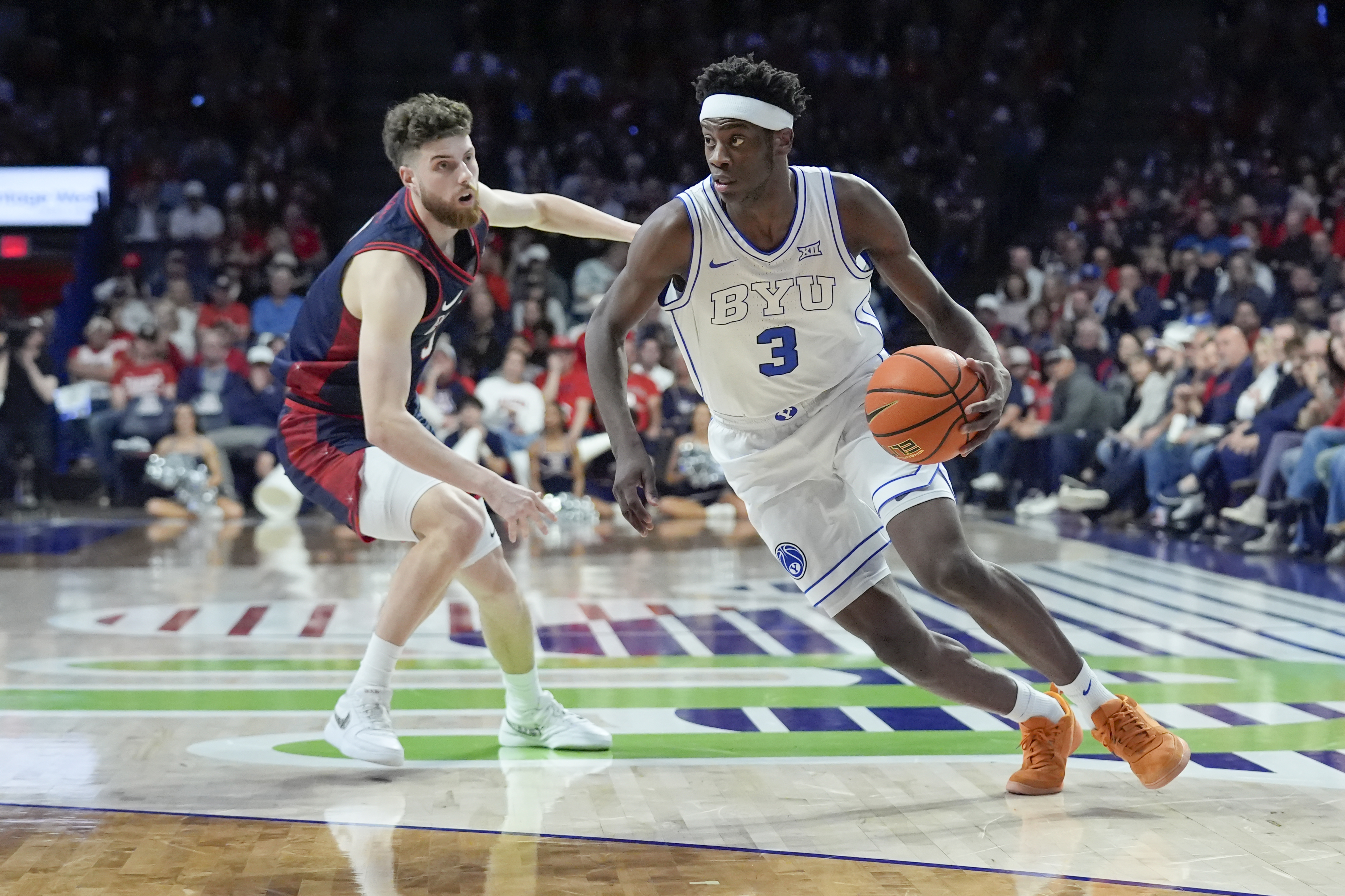BYU's AJ Dybantsa displaying his speed as he drives past Arizona's Anthony Dell'orso in a game on Feb. 18