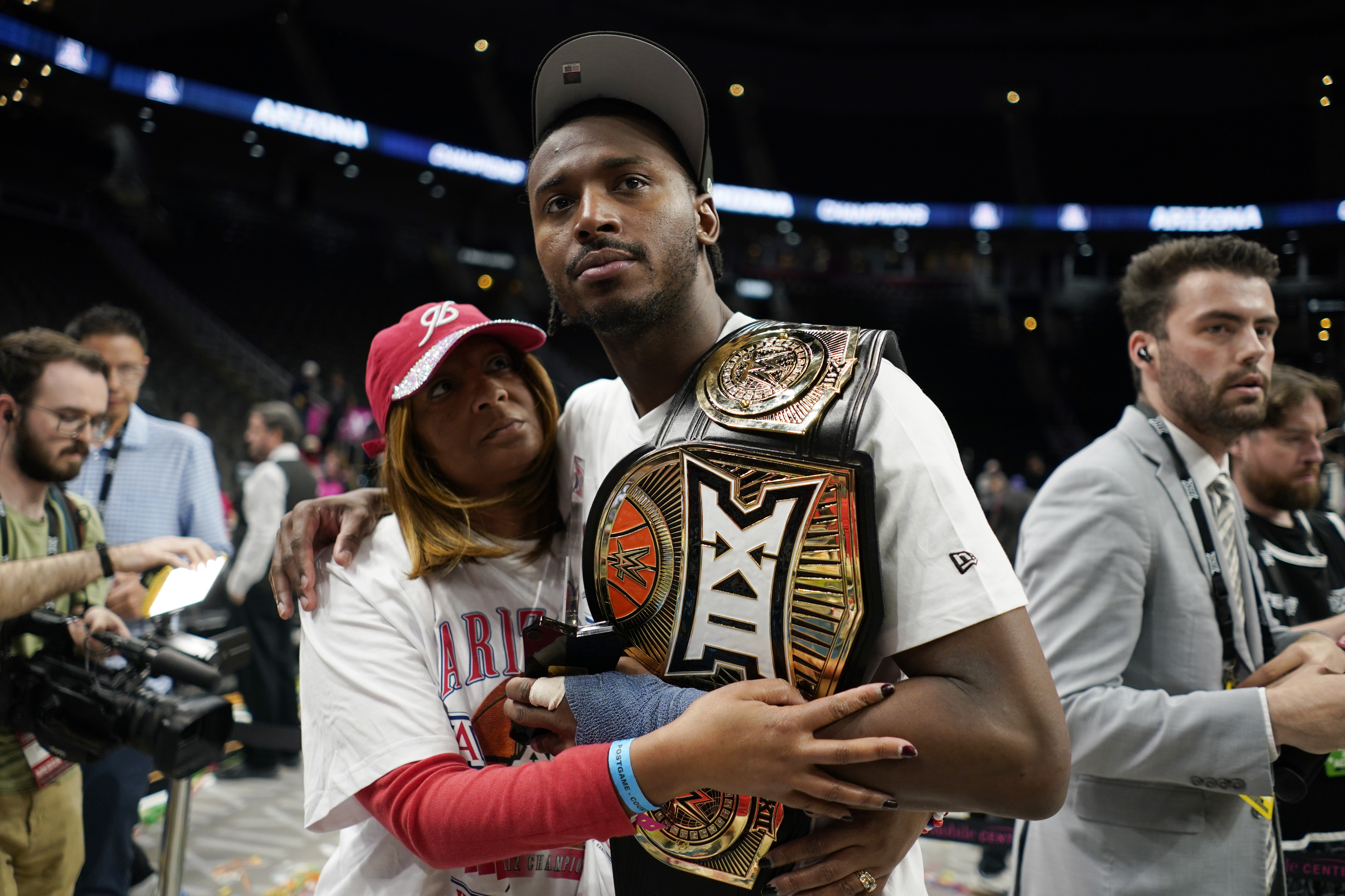 Big 12 Player of the Year Jaden Bradley celebrating Arizona's conference tournament championship
