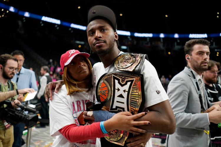 Big 12 Player of the Year Jaden Bradley celebrating Arizona's conference tournament championship