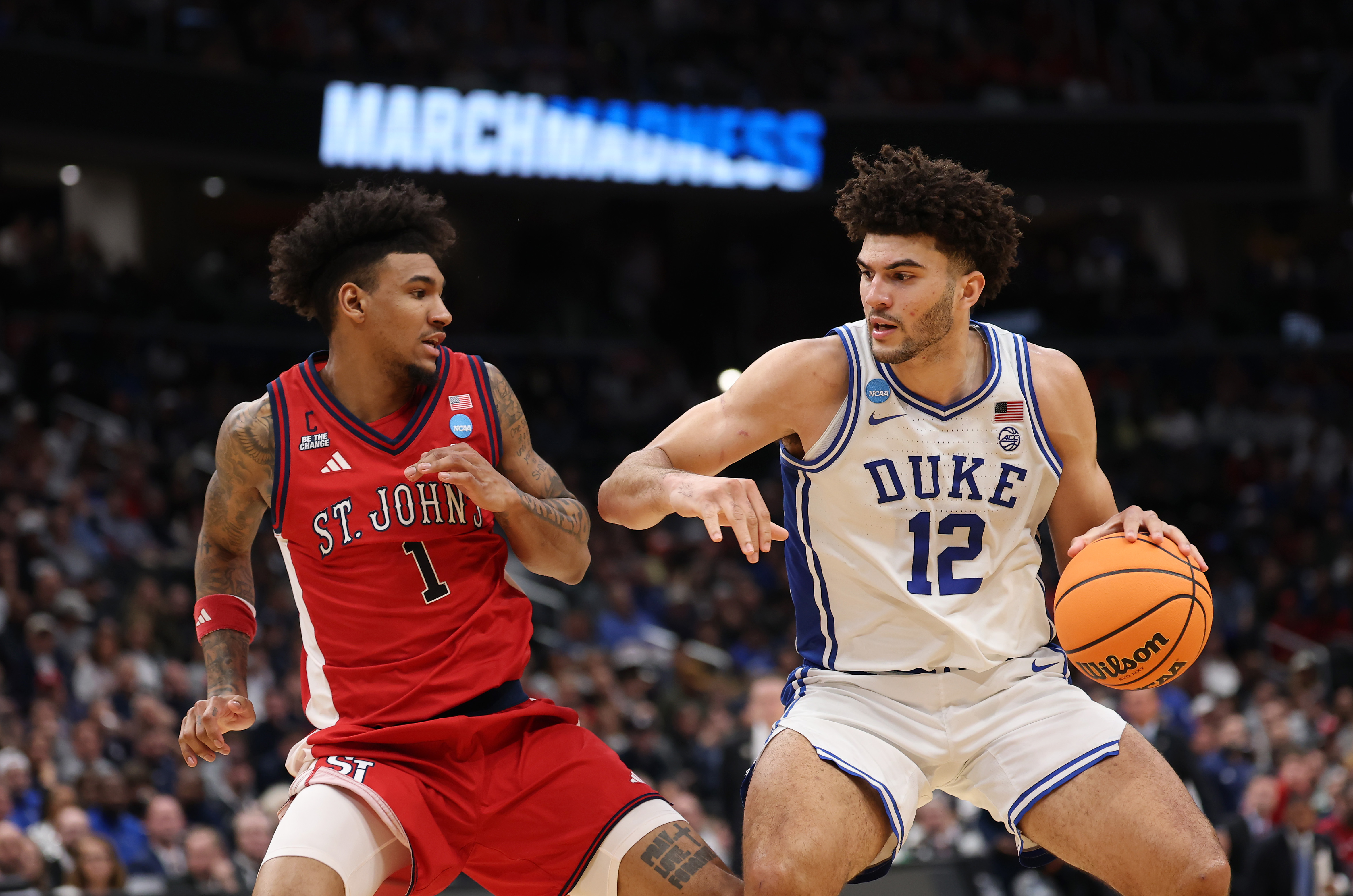 Duke basketball Cameron Boozer battles St. John's player Dillon Mitchell.