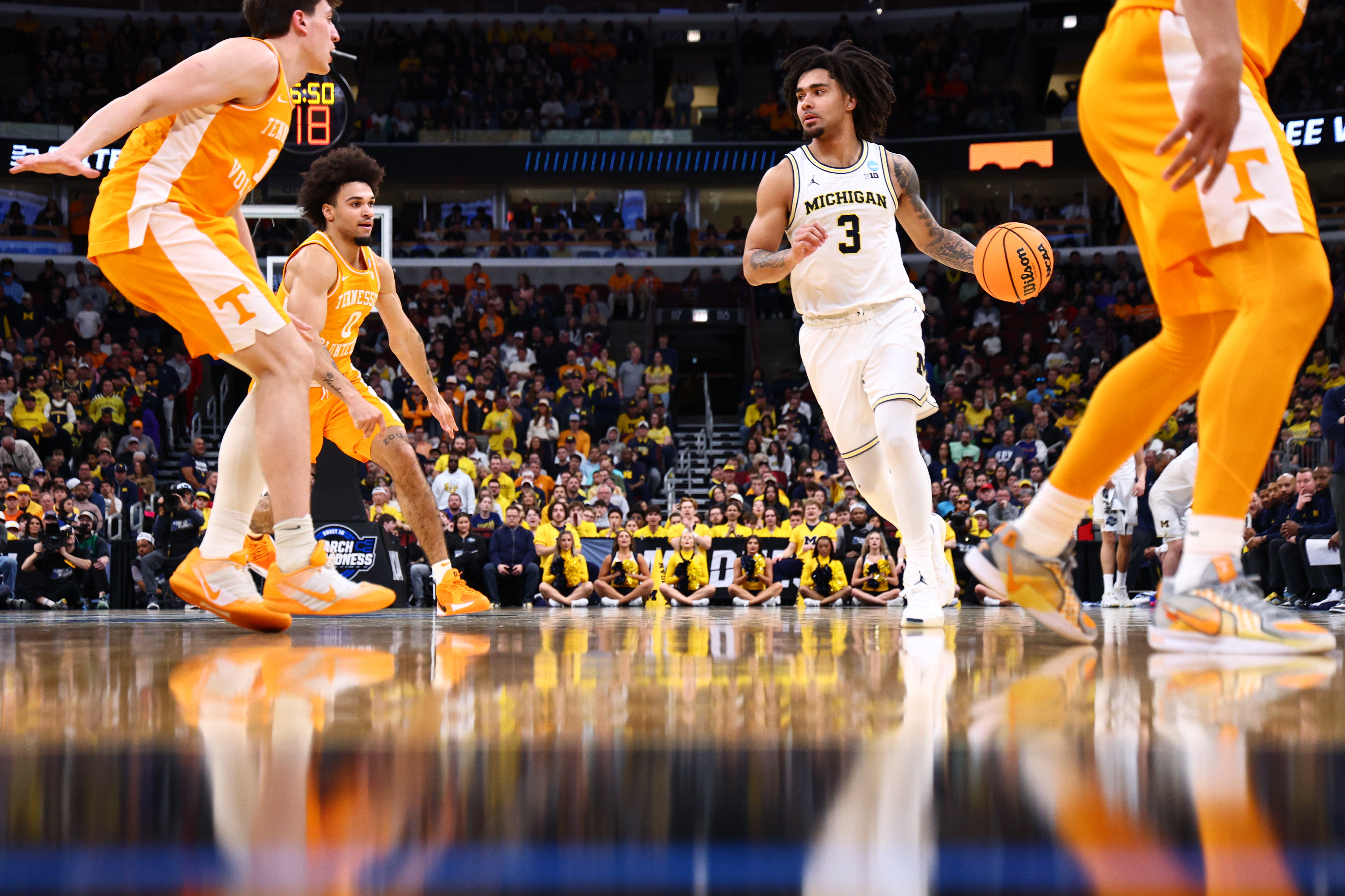 Elliot Cadeau #3 of the Michigan Wolverines dribbles the ball against the Tennessee Volunteers during the first half of the Elite Eight