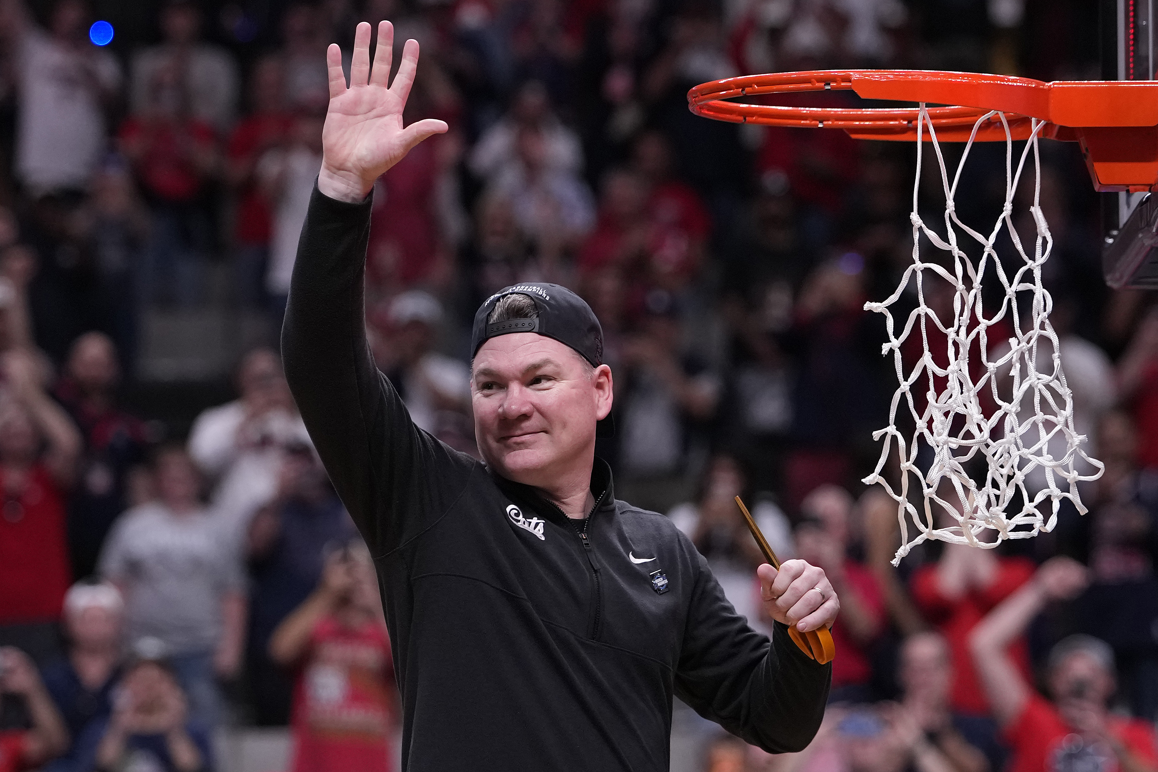 Arizona coach Tommy Lloyd celebrates his team's win