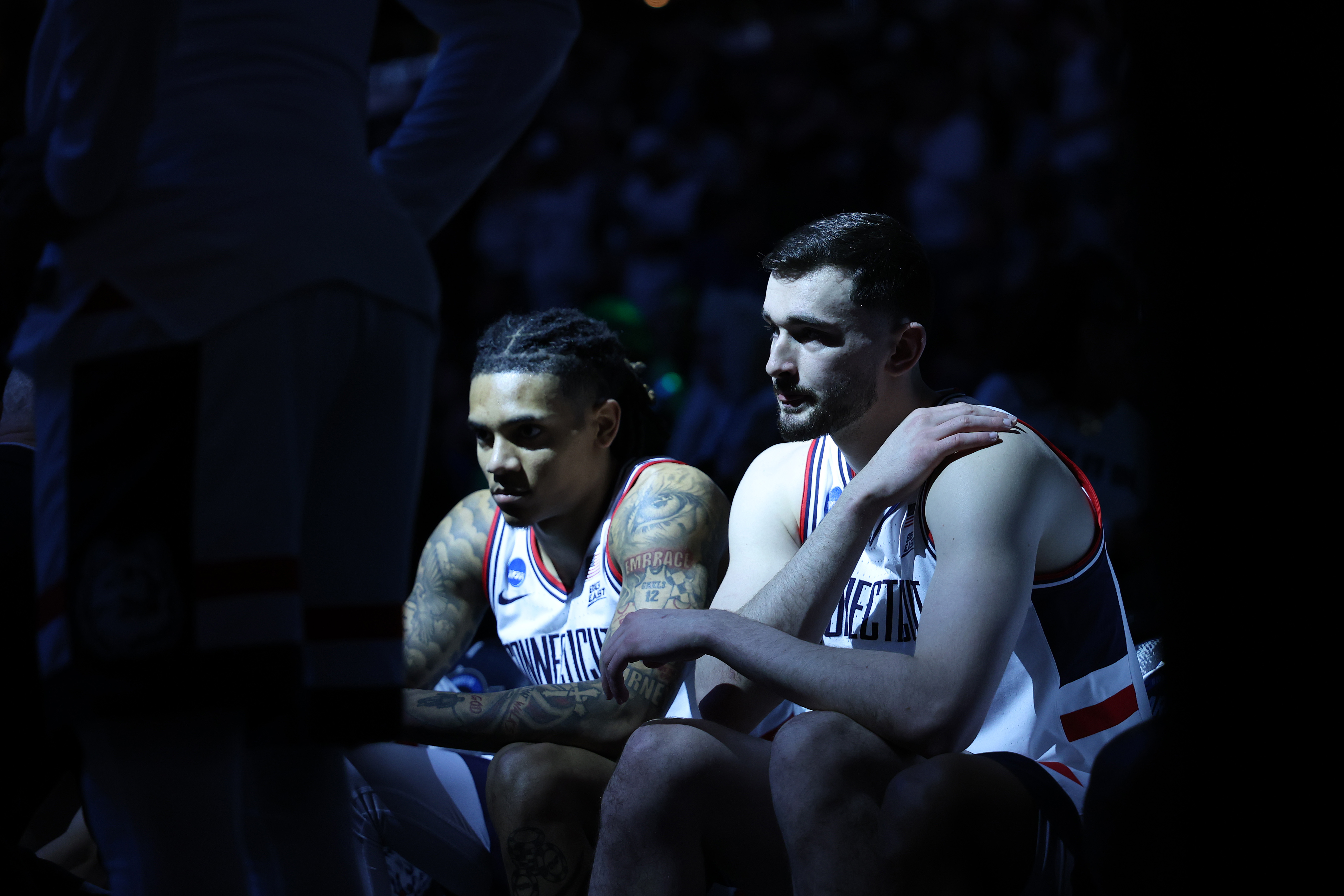 Alex Karaban illuminated on the UConn bench