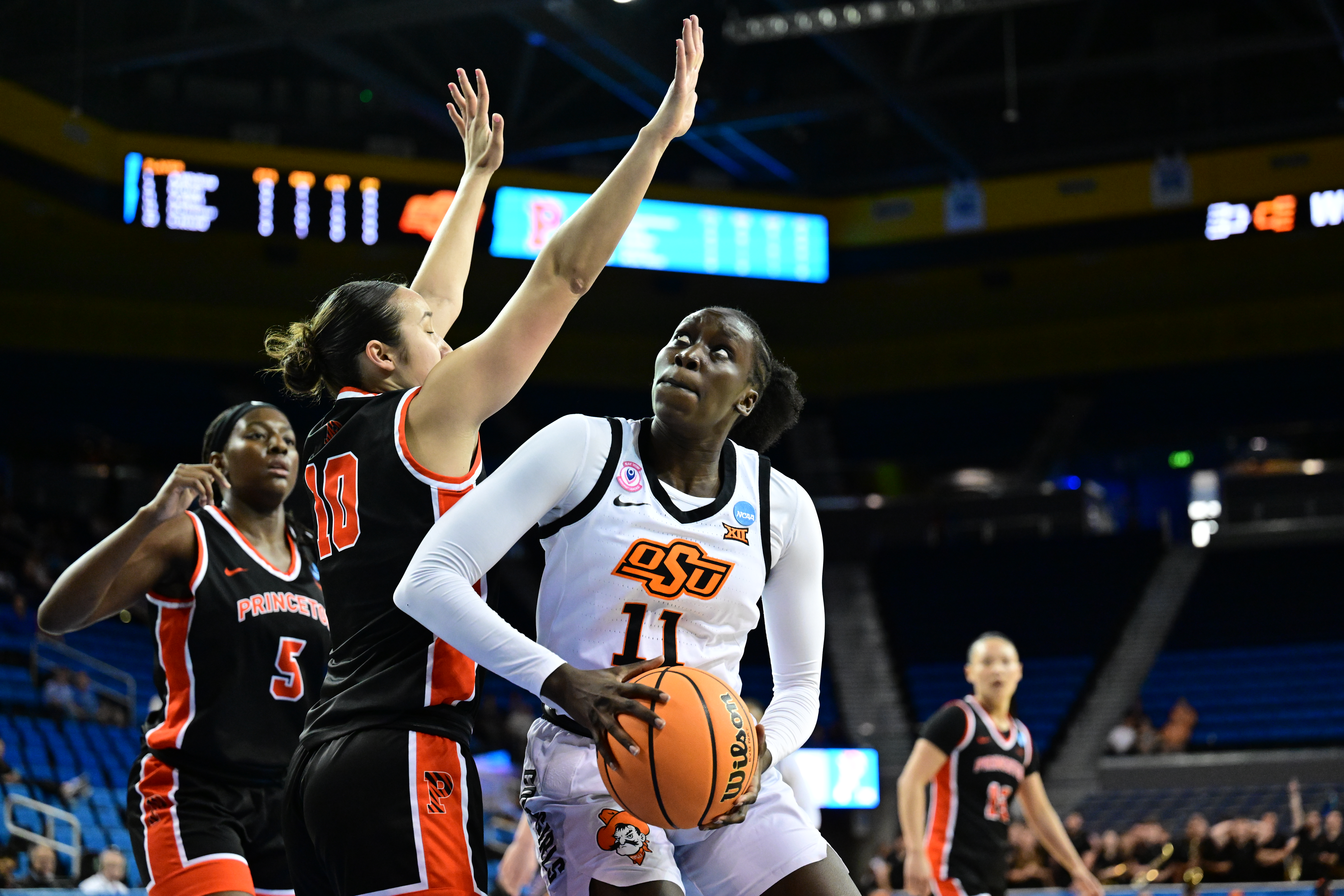 Achol Akot (#11) is moving from Oklahoma State to UNC and hopes to help the Tar Heels at both ends of the floor