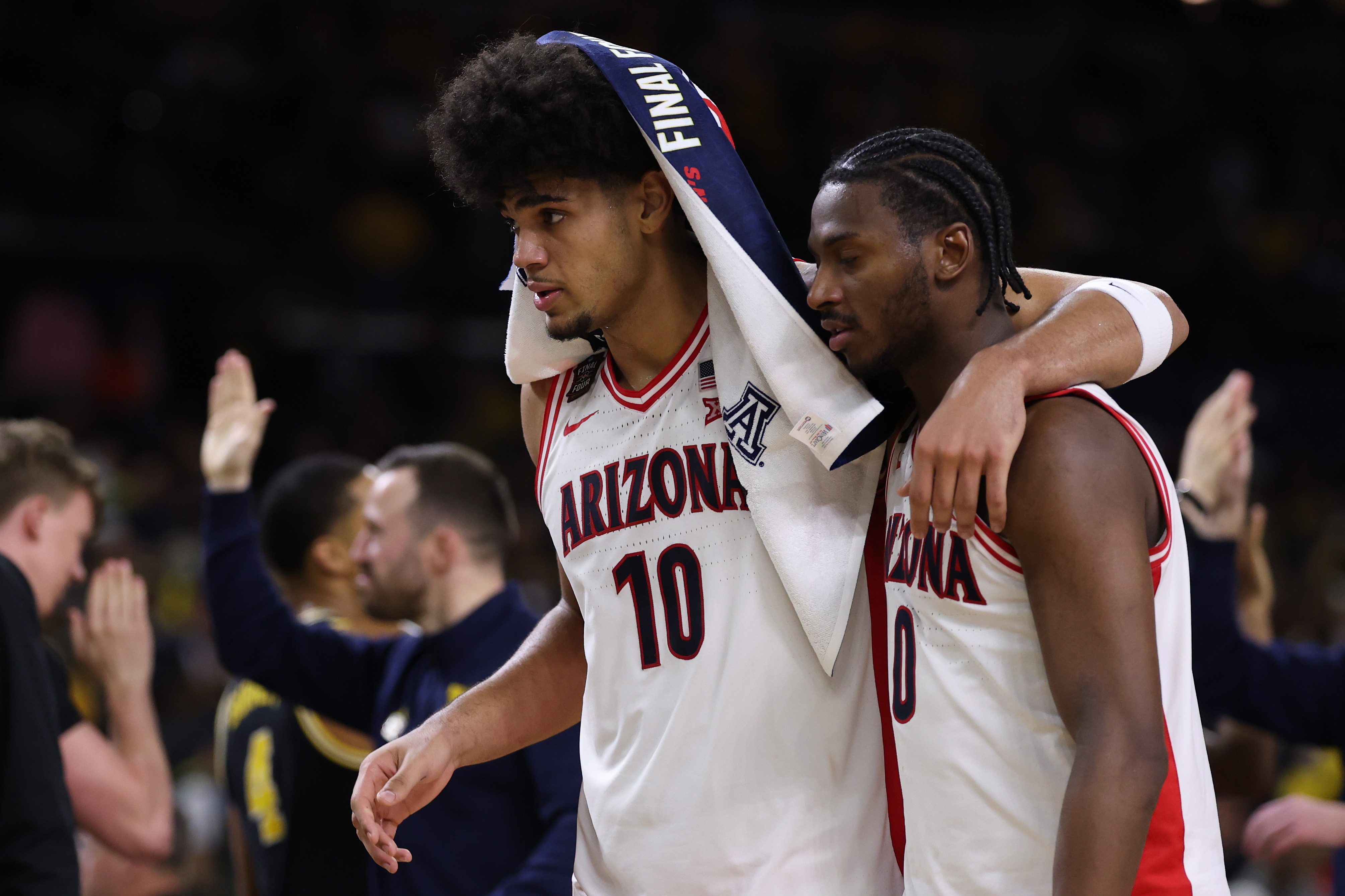 A dejected Koa Peat and Jaden Bradley walk to the Arizona bench after losing to Michigan in the 2026 Final Four