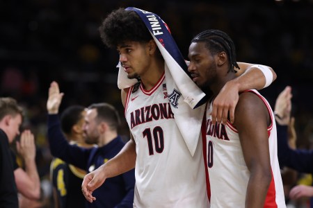 A dejected Koa Peat and Jaden Bradley walk to the Arizona bench after losing to Michigan in the 2026 Final Four