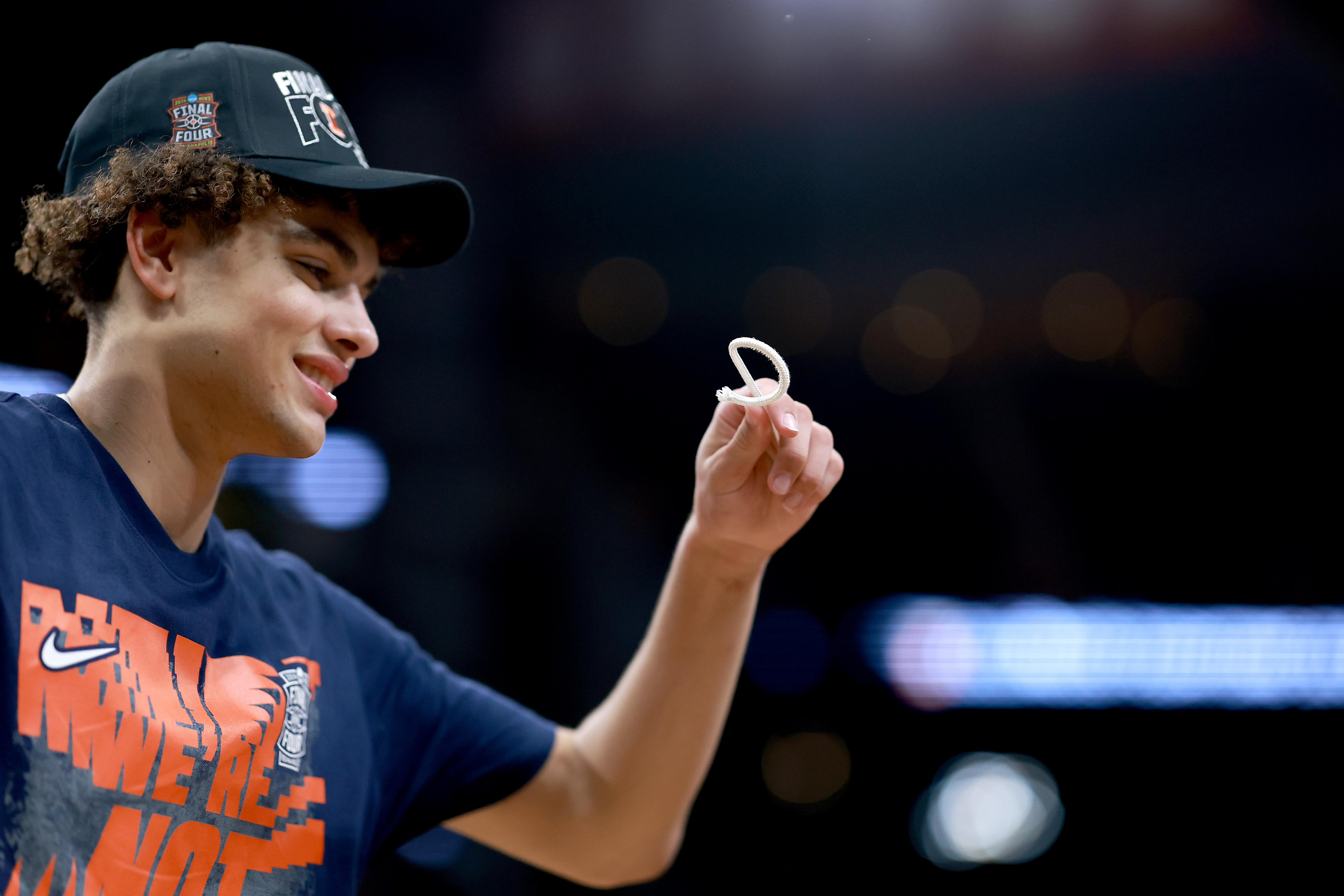 Keaton Wagler holds a piece of the net after Illinois' Elite Eight win