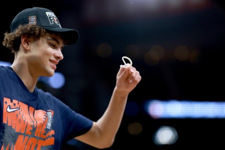 Keaton Wagler holds a piece of the net after Illinois' Elite Eight win