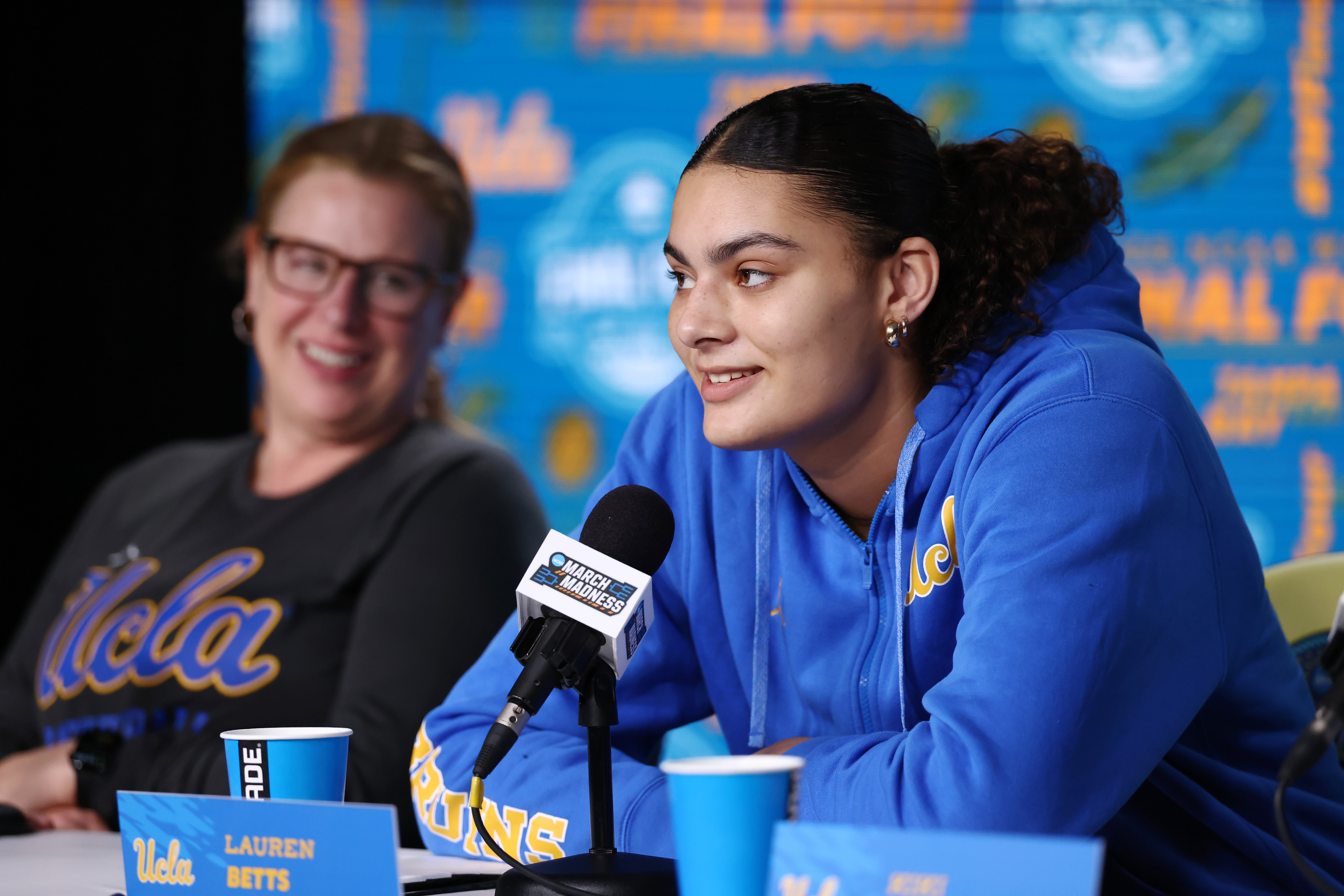 Coach Cori Close looks at Lauren Betts affectionately