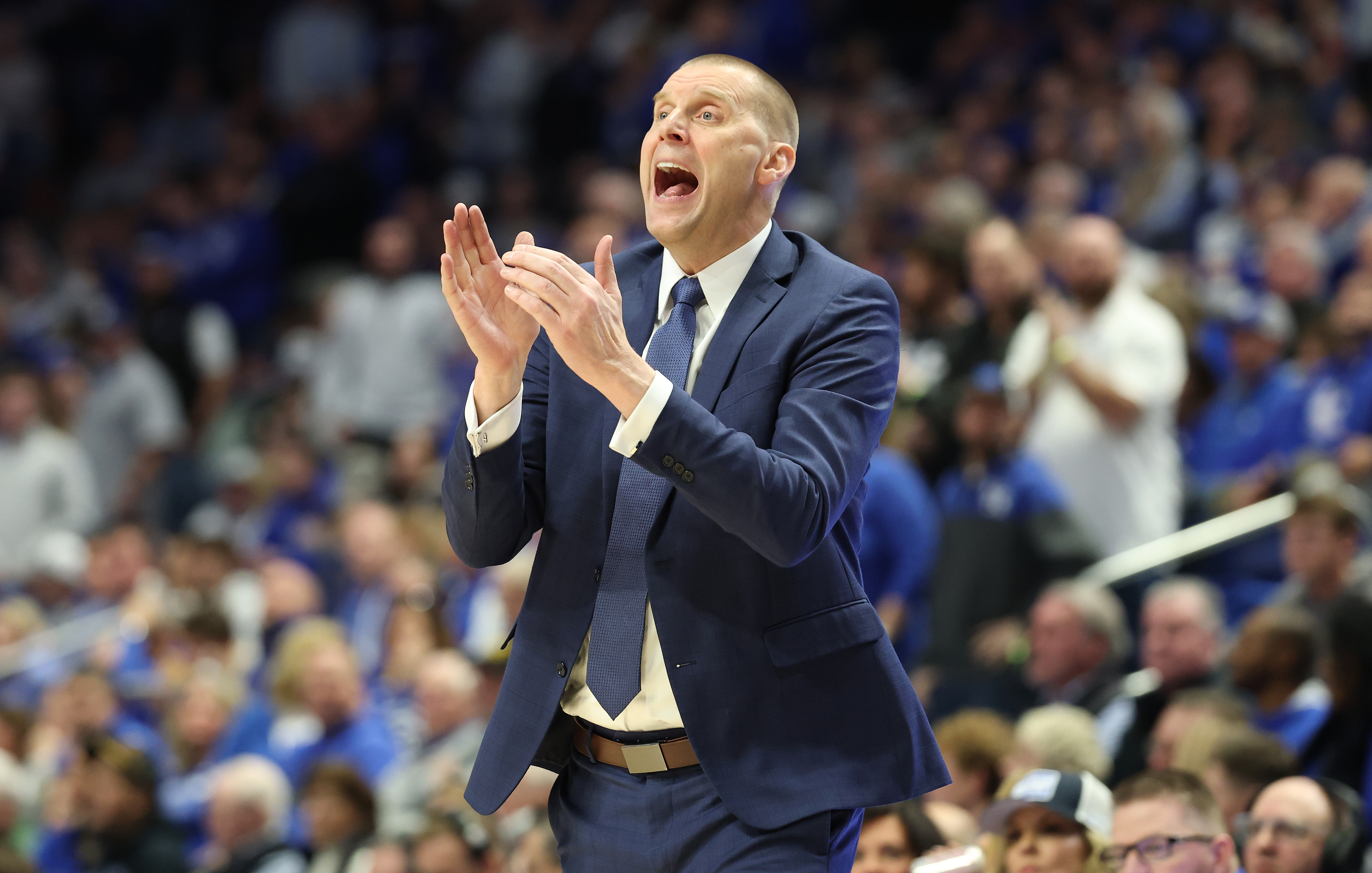 Mark Pope attempting to get his players' attention while coaching from the Kentucky sidelines
