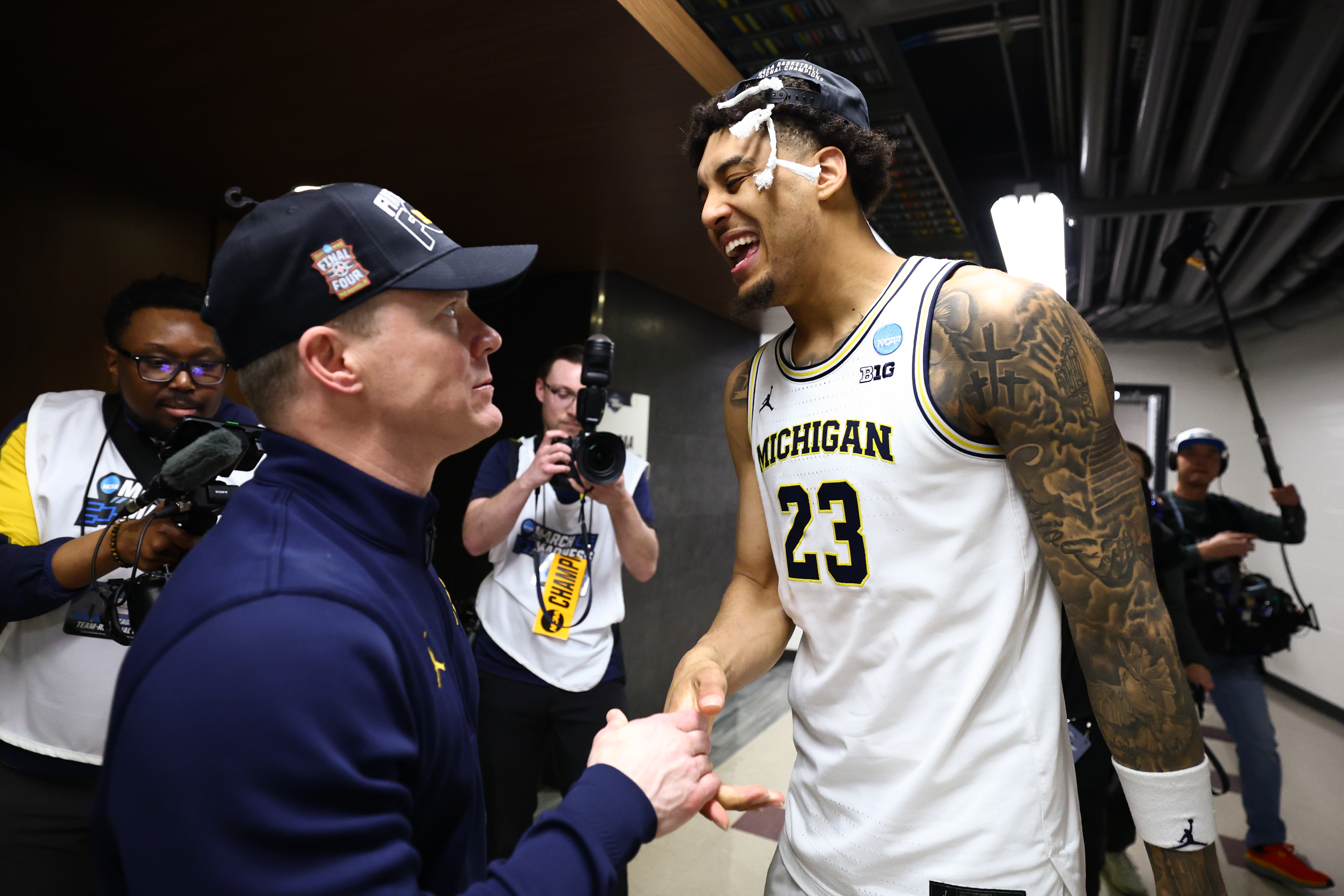 Dusty May and Yaxel Lendeborg celebrate after Michigan's Elite Eight win over Tennessee