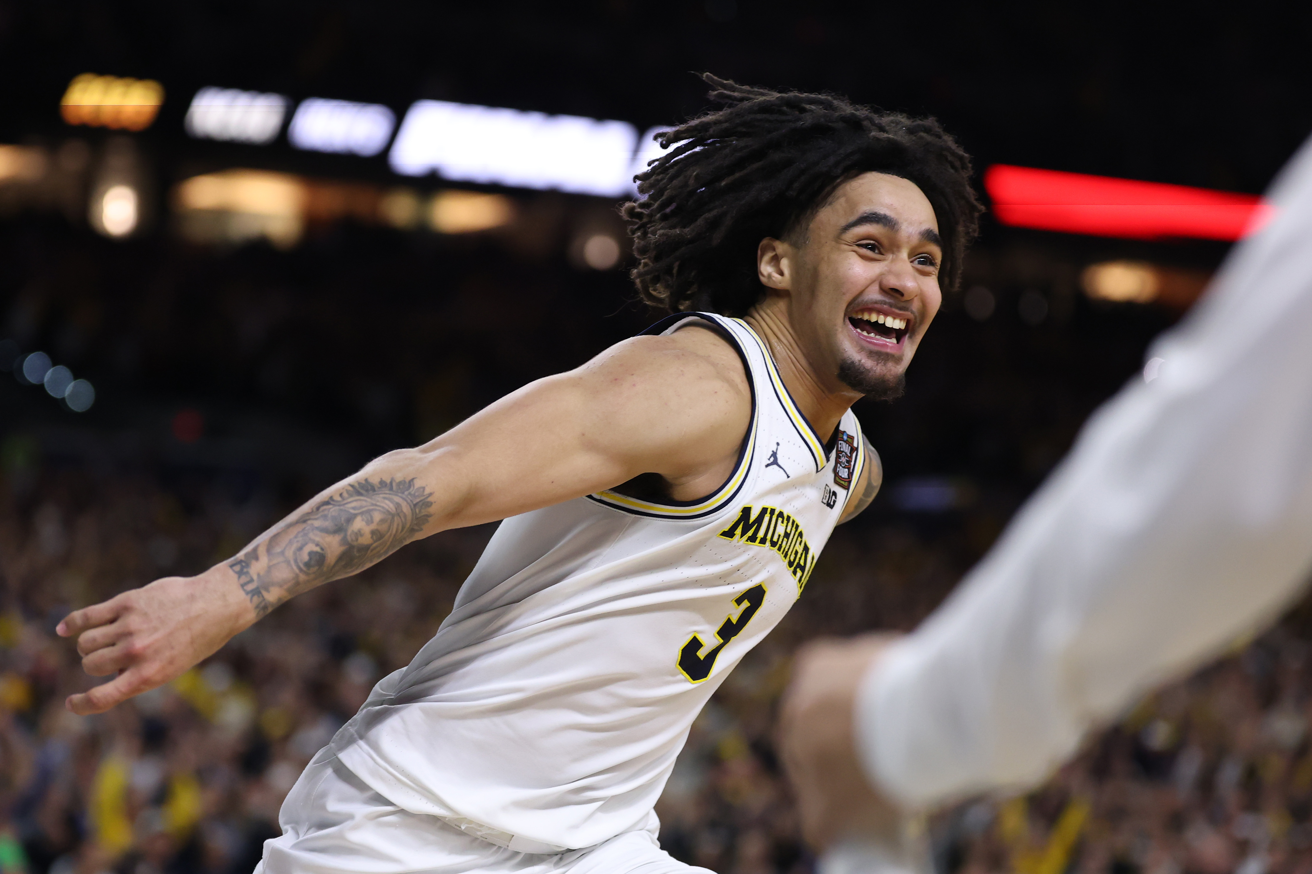 Michigan guard Elliot Cadeau smiling as he celebrates the Wolverines' 2026 NCAA Championship following a win over UConn