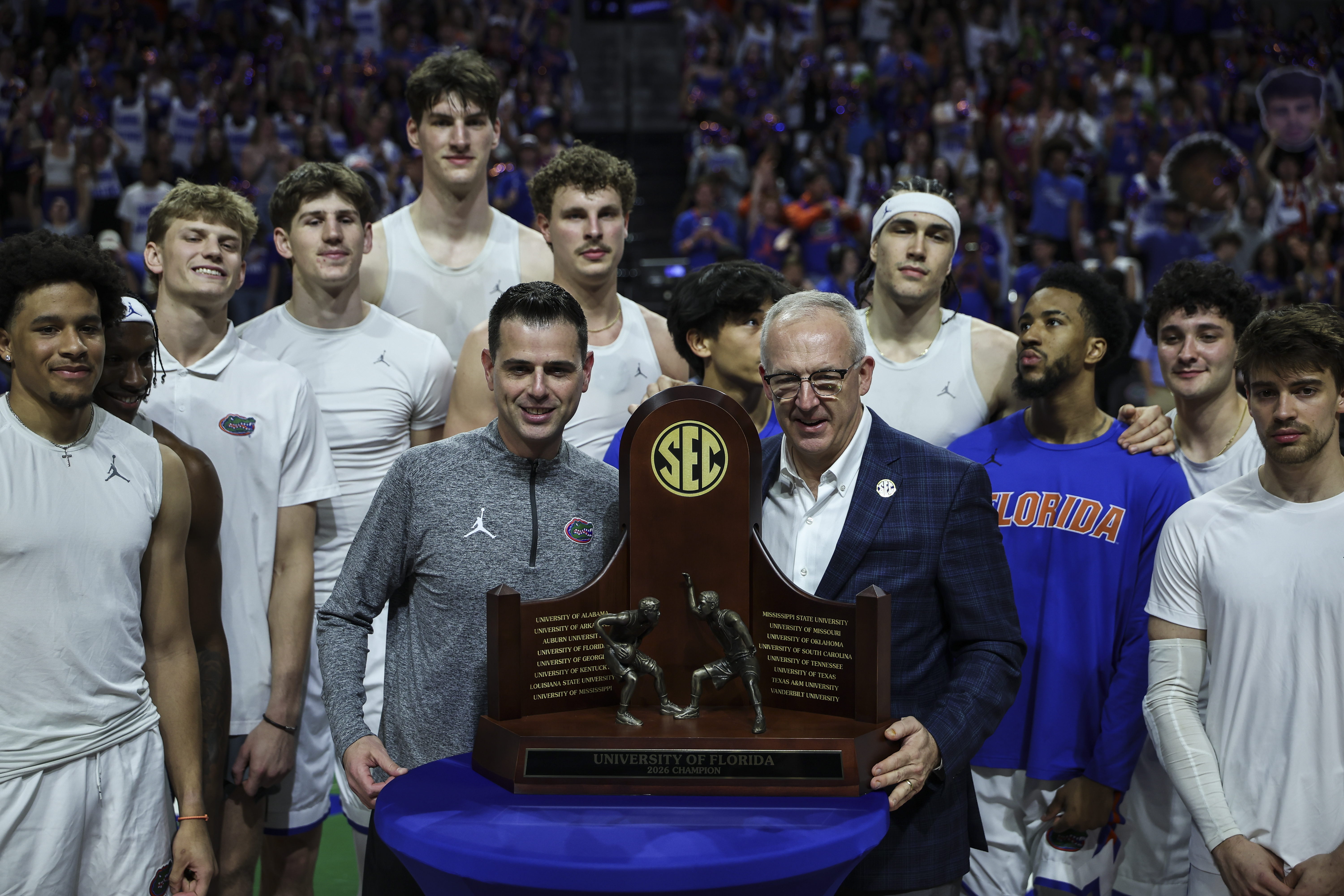 SEC Commissioner Greg Sankey poses with the conference champion Florida Gators