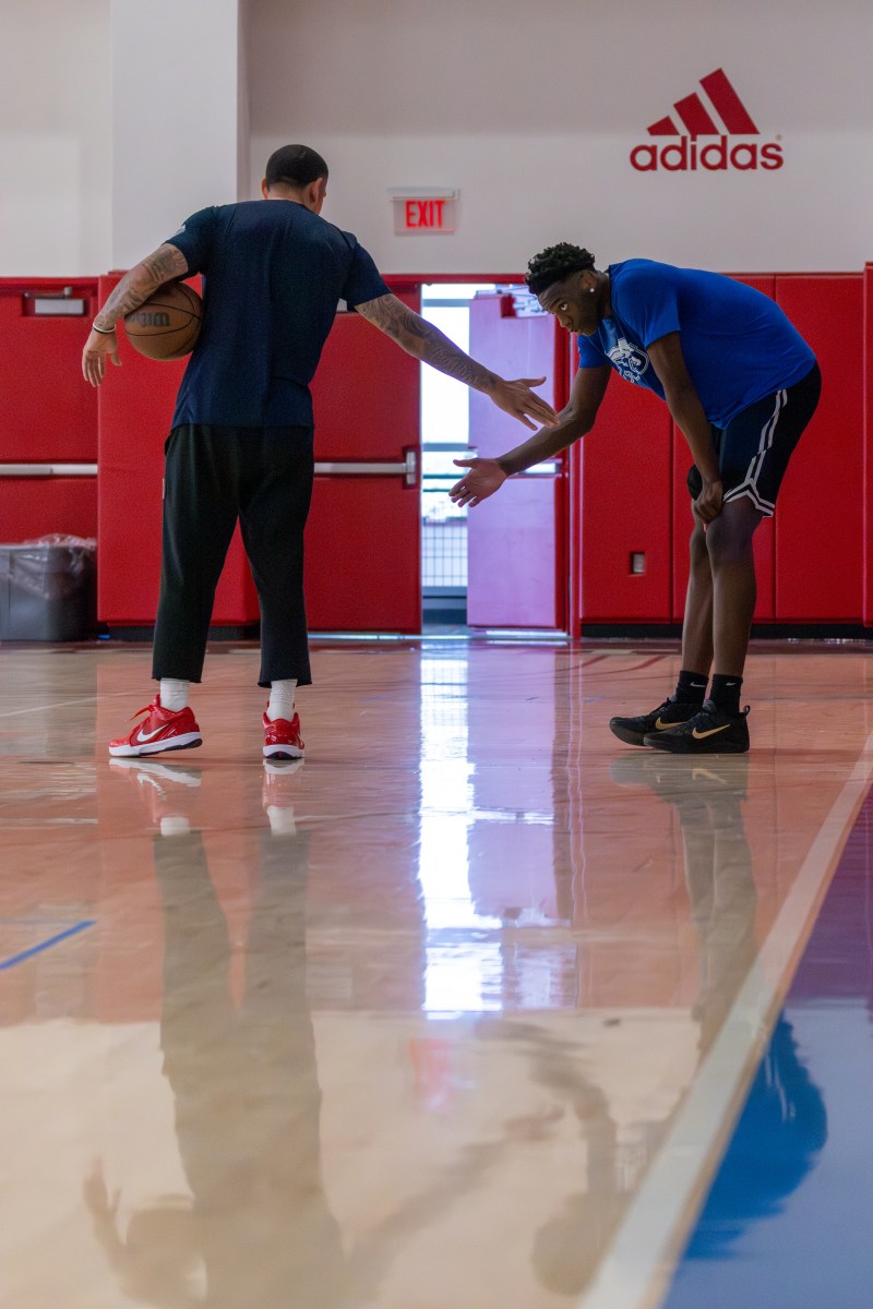 A.J.'s trainer Zack Gonzales offers encouragement after a drill