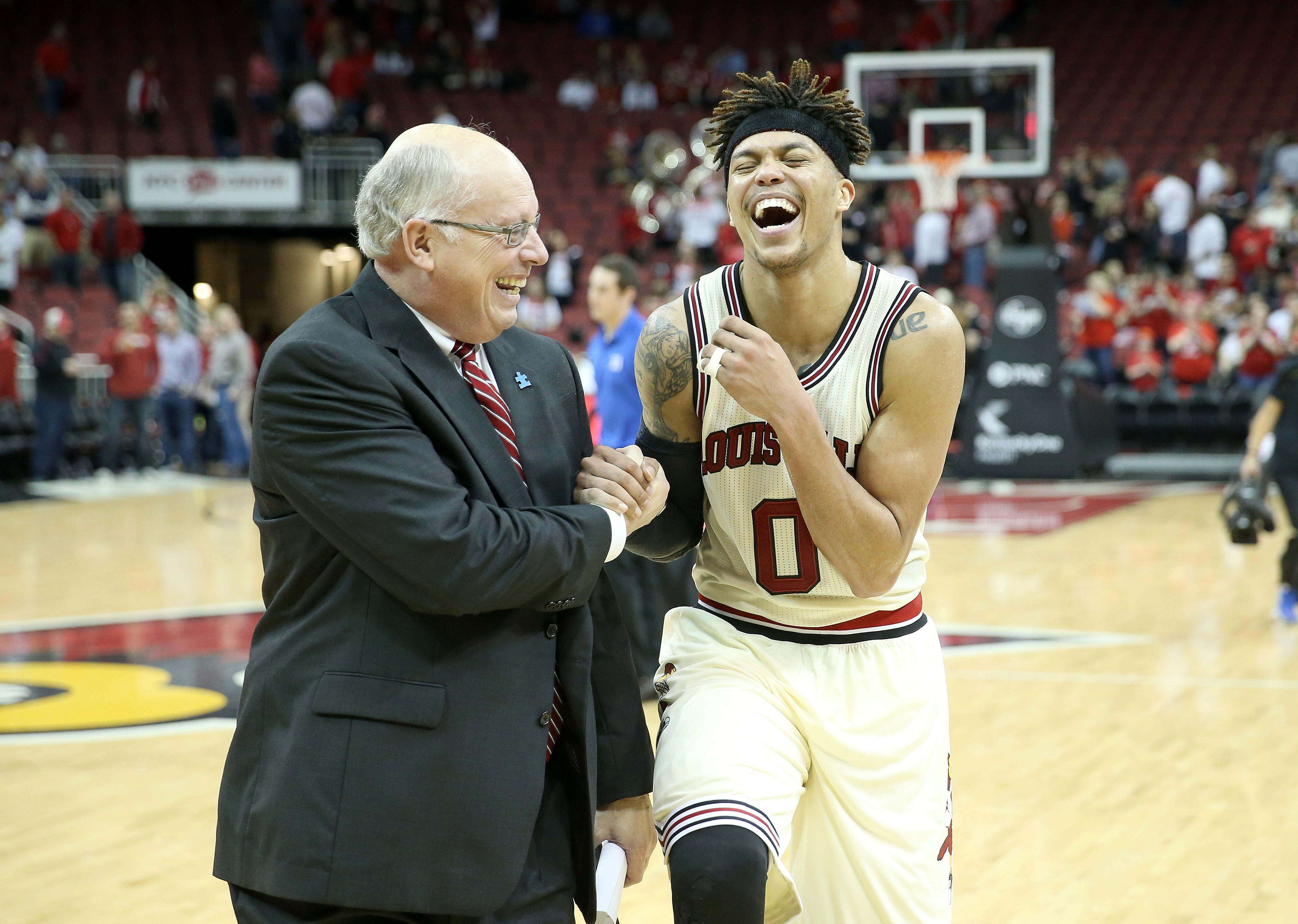 Kenny Klein celebrates with Louisville great Damion Lee after a win vs. Duke