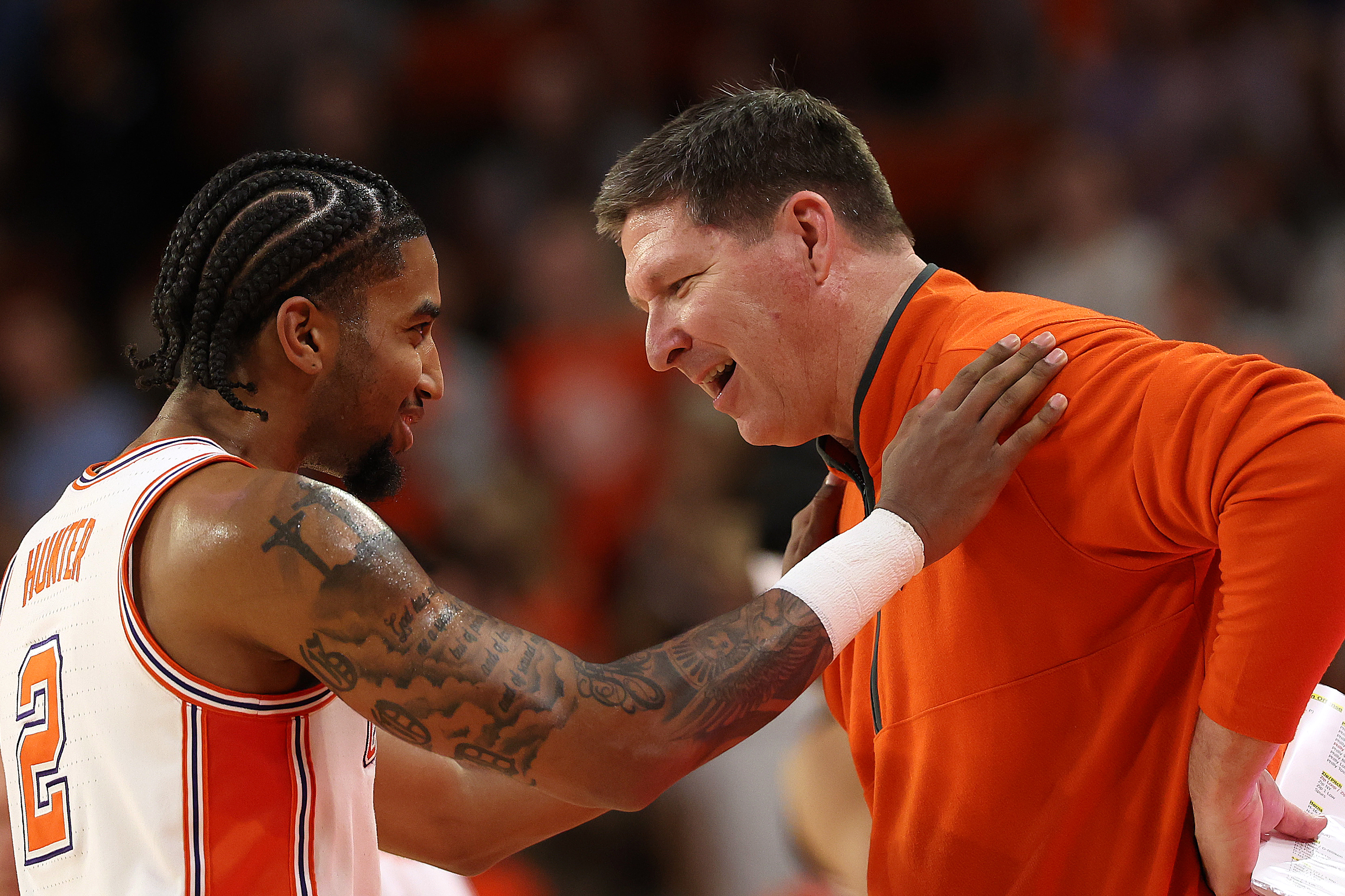 Brad Brownell speaks to Dillon Hunter during a game against the Louisville Cardinals
