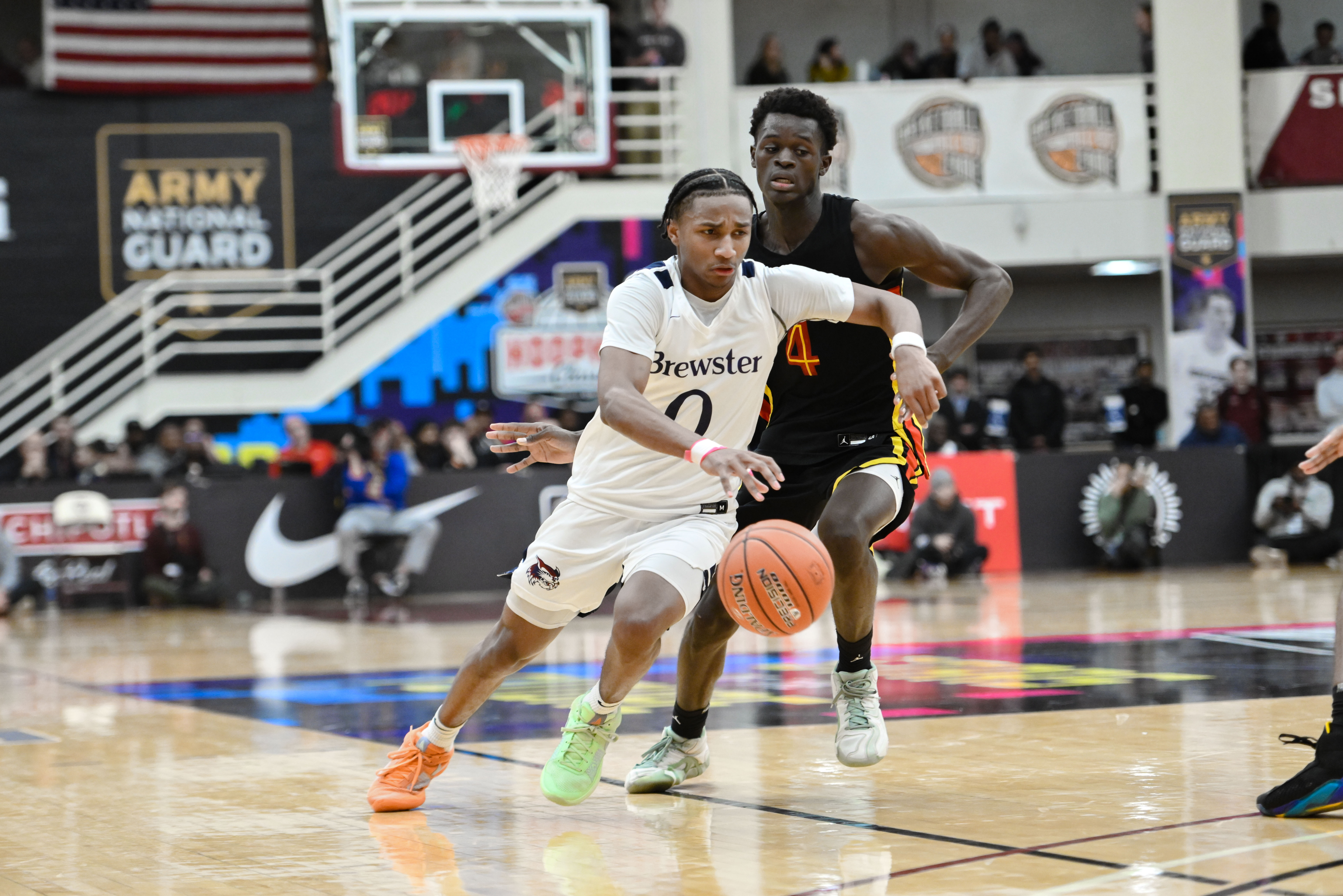 Antonio Pemberton of Brewster Academy drives past Cheikh Biteye of Oak Hill Academy during the 2025 Spalding Hoophall Classic